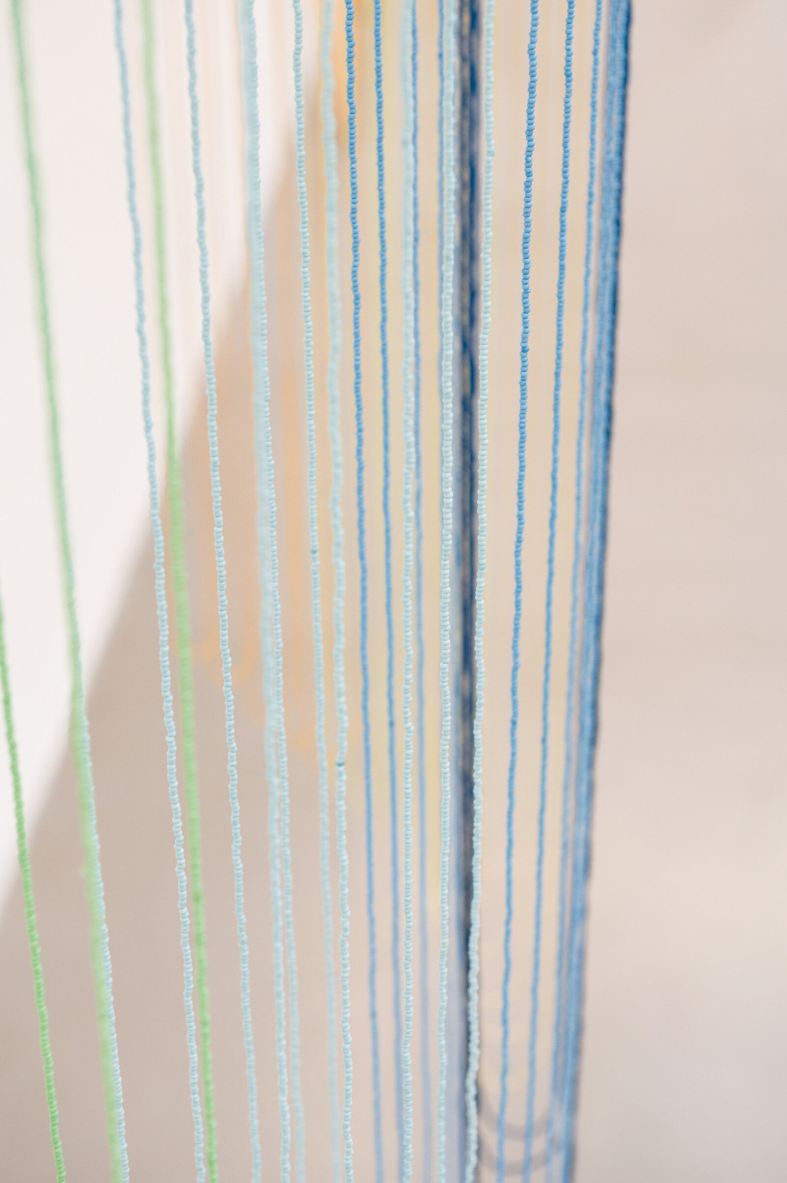 Tanya Lukin Linklater, Headwaters (detail), 2026, 45 circular beaded strands, bentwood ash, seed beads, thread (fishing line), deer hide, 35 x 68 x 29 in. (89 x 173 x 72 cm)
