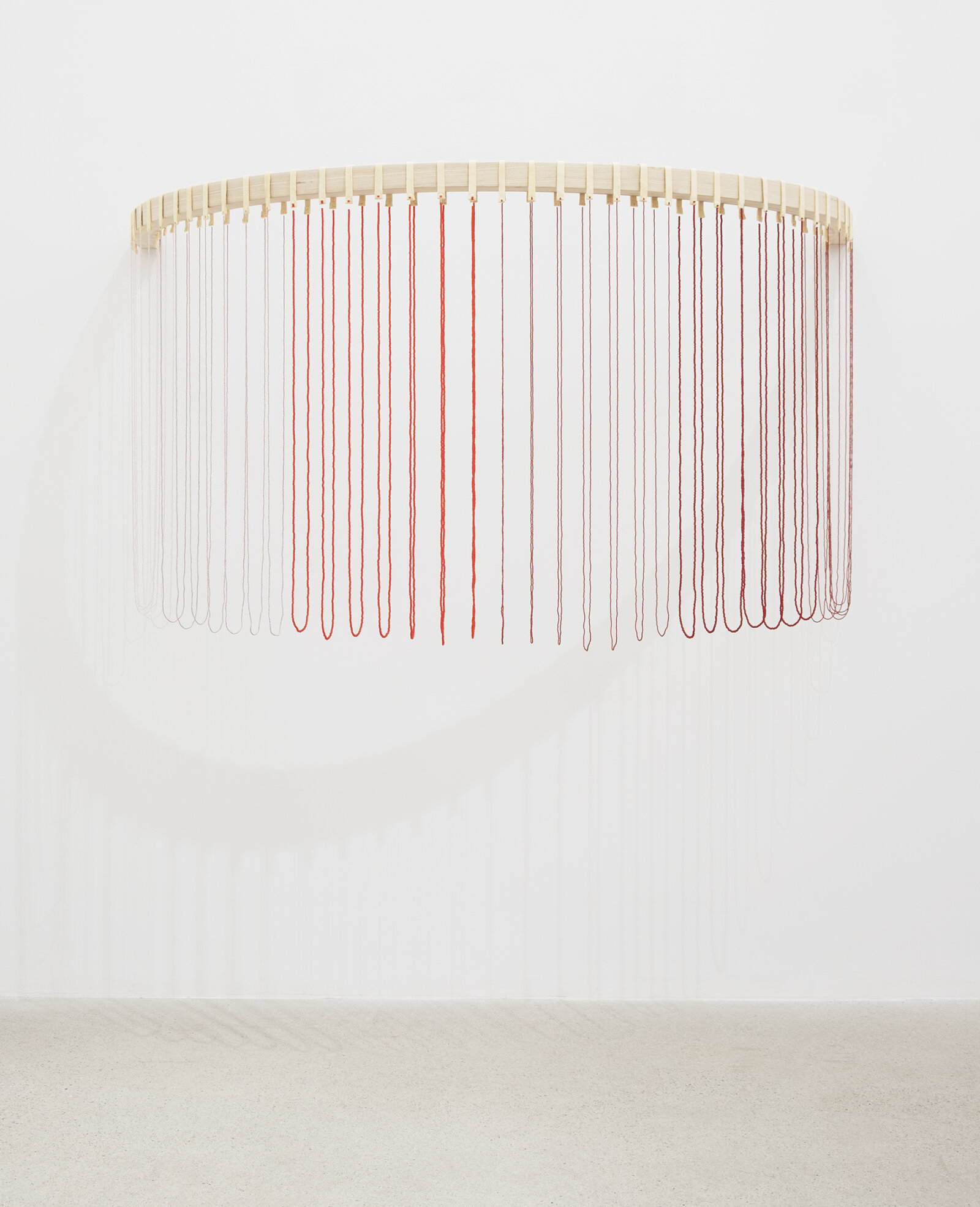 Tanya Lukin Linklater, ochre-smeared earth, 2026, 42 circular beaded strands, bentwood ash, seed beads, thread (fishing line), deer hide, 35 x 68 x 29 in. (89 x 173 x 72 cm)