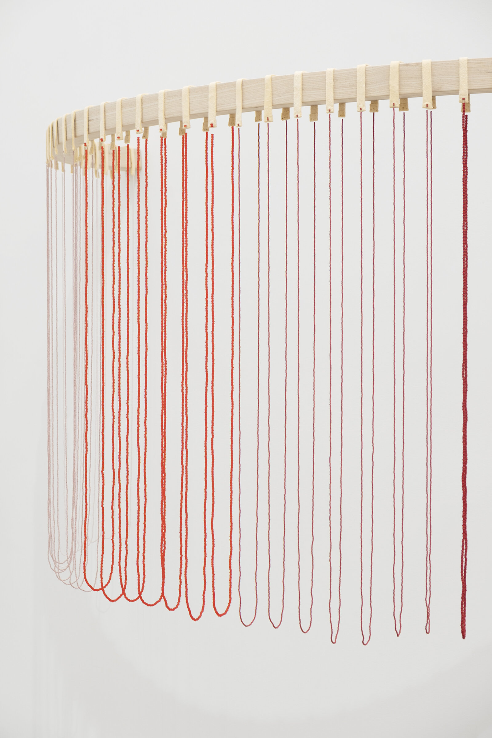 Tanya Lukin Linklater, ochre-smeared earth (detail), 2026, 42 circular beaded strands, bentwood ash, seed beads, thread (fishing line), deer hide, 35 x 68 x 29 in. (89 x 173 x 72 cm)