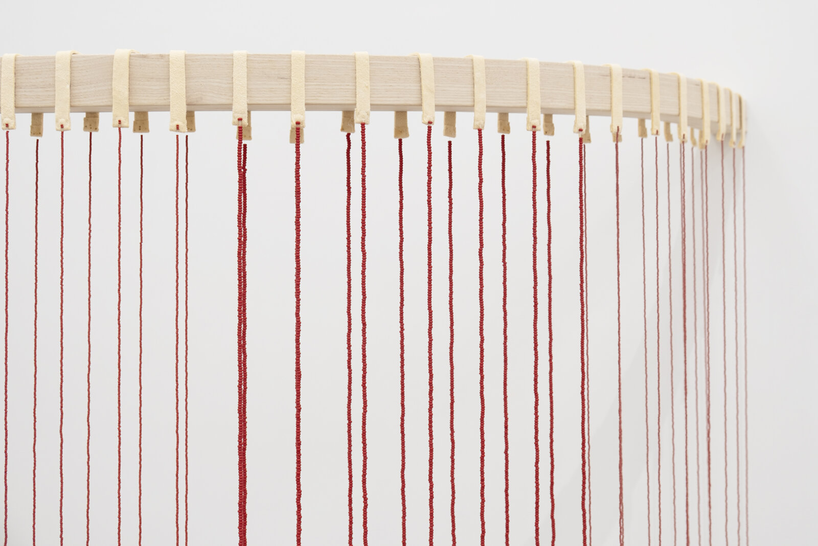 Tanya Lukin Linklater, ochre-smeared earth (detail), 2026, 42 circular beaded strands, bentwood ash, seed beads, thread (fishing line), deer hide, 35 x 68 x 29 in. (89 x 173 x 72 cm)
