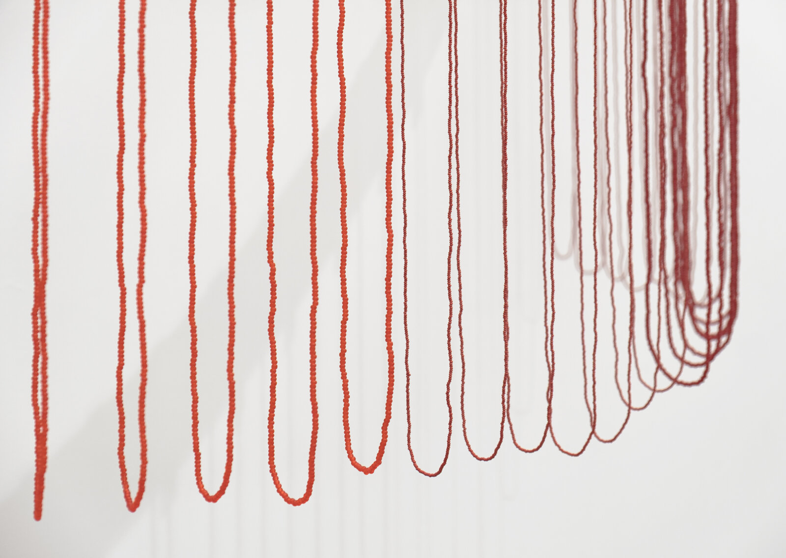 Tanya Lukin Linklater, ochre-smeared earth (detail), 2026, 42 circular beaded strands, bentwood ash, seed beads, thread (fishing line), deer hide, 35 x 68 x 29 in. (89 x 173 x 72 cm)