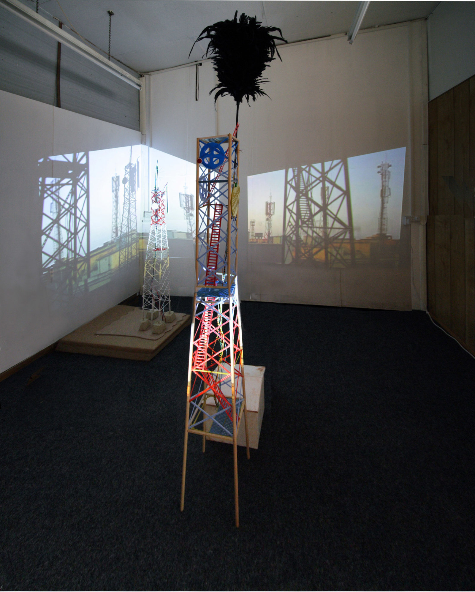 Christina Mackie, Karachi, 2006, wood, wire, plastics, cement, plaster, projectors, players, media, inkjet prints, cardboard, dimensions variable