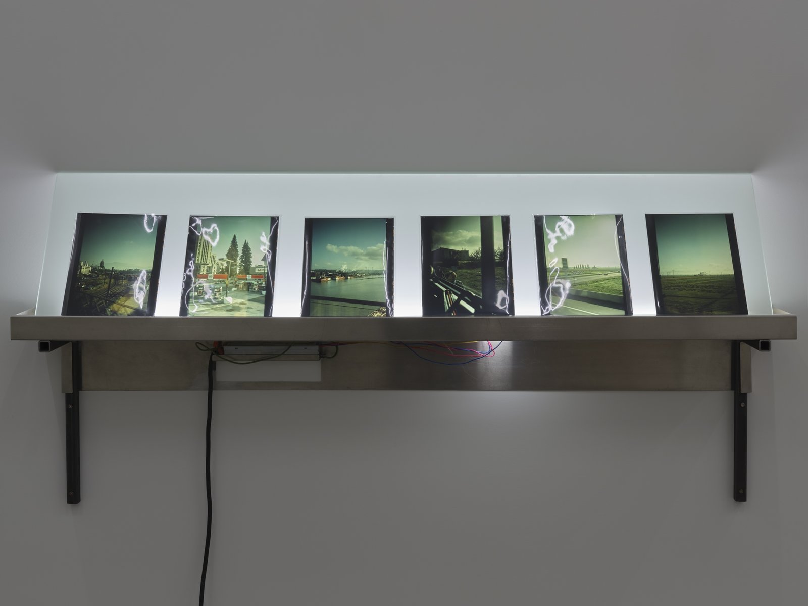 Christina Mackie, Lightbox (The confusion part II), 2012, aluminum, steel, fluorescent lamps, glass, neoprene, photographic transparencies 1973, 30 x 66 x 8 in. (76 x 168 x 21 cm)