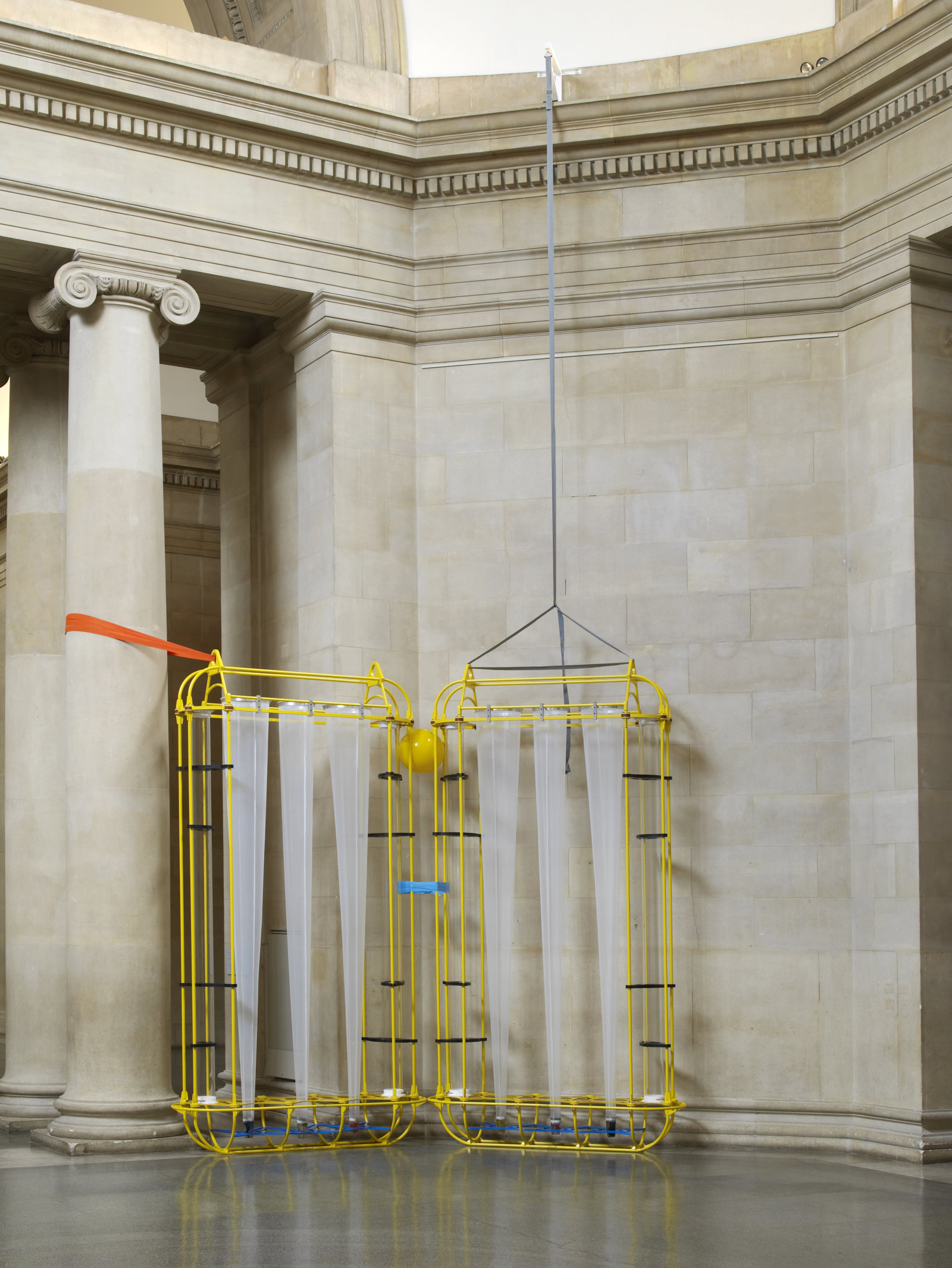 Christina Mackie, The Yellow Machines, 2015, steel, aluminum, acrylic, styrene, copper, stainless steel, nylon webbing, polyethylene, nylon, resin, rubber, 128 x 160 x 32 in. (326 x 406 x 80 cm). Installation view, the filters, Tate Britain, London, UK, 2015