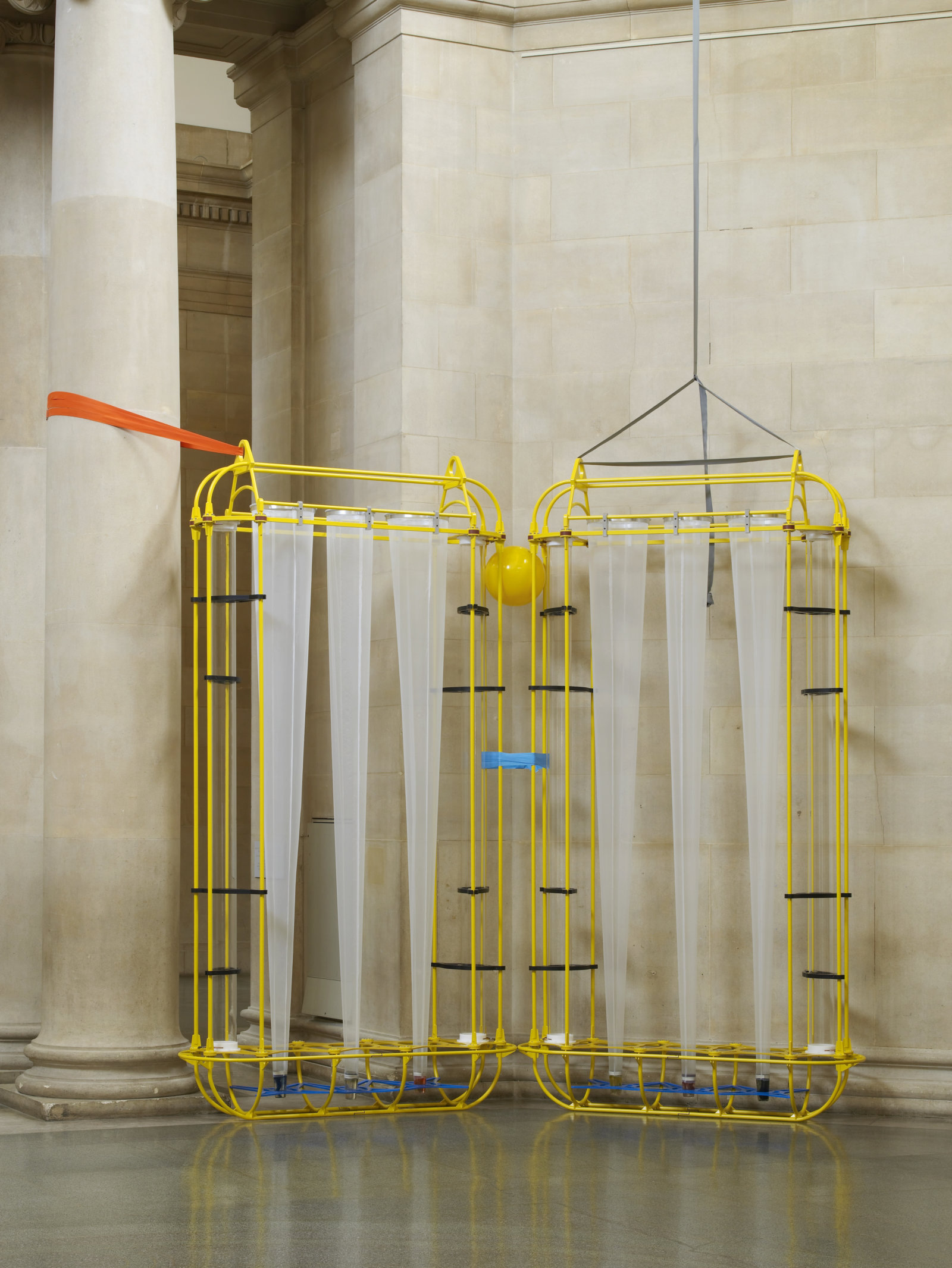 Christina Mackie, The Yellow Machines, 2015, steel, aluminum, acrylic, styrene, copper, stainless steel, nylon webbing, polyethylene, nylon, resin, rubber, 128 x 160 x 32 in. (326 x 406 x 80 cm). Installation view, the filters, Tate Britain, London, UK, 2015