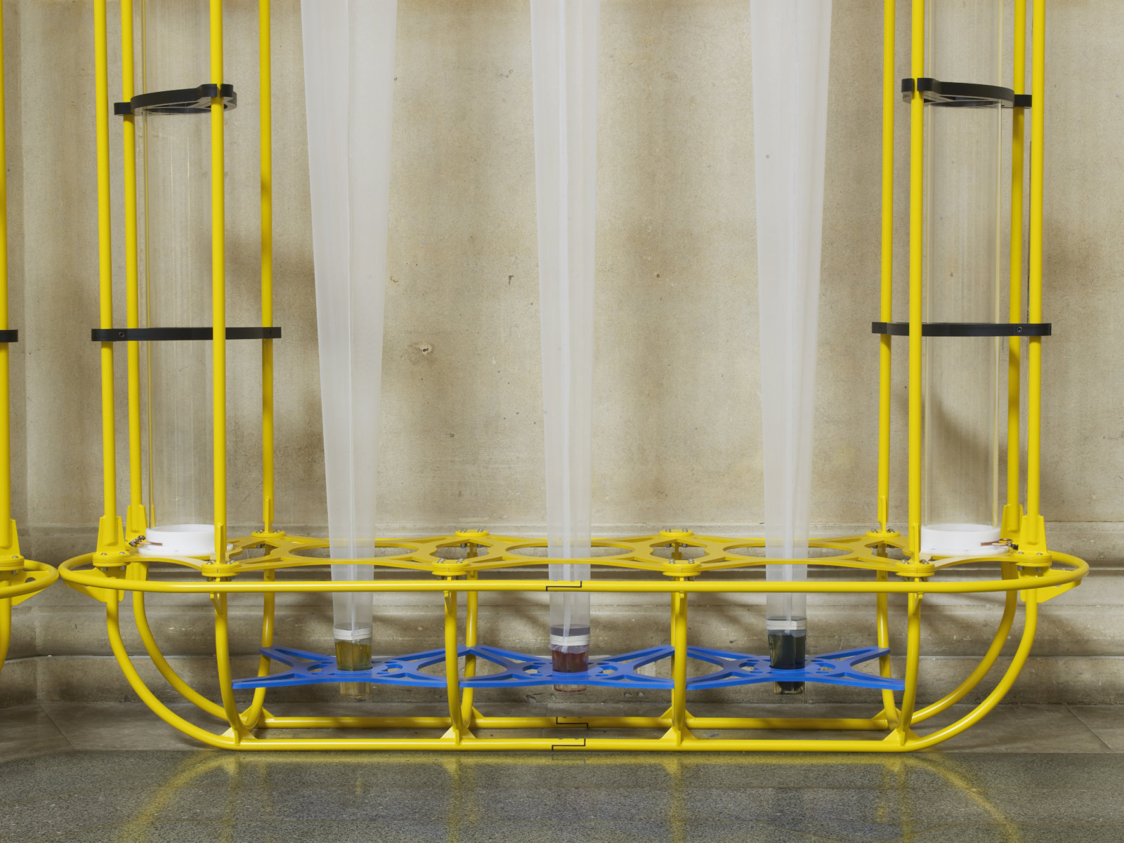 Christina Mackie, The Yellow Machines (detail), 2015, steel, aluminum, acrylic, styrene, copper, stainless steel, nylon webbing, polyethylene, nylon, resin, rubber, 128 x 160 x 32 in. (326 x 406 x 80 cm). Installation view, the filters, Tate Britain, London, UK, 2015