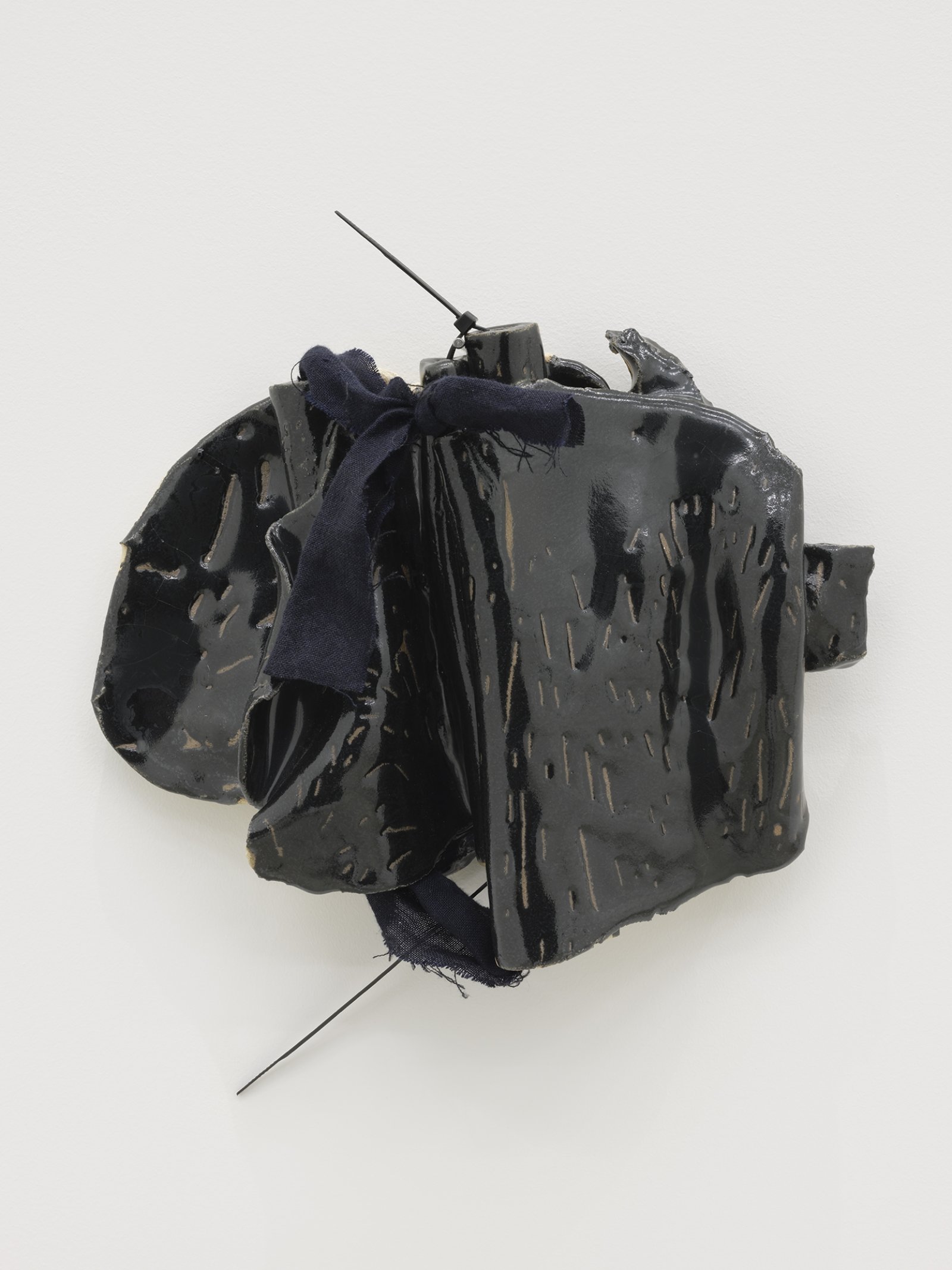 Christina Mackie, Token no. 10, 2019, stoneware, linen, cable ties, nail, 14 x 13 in. (36 x 32 cm)