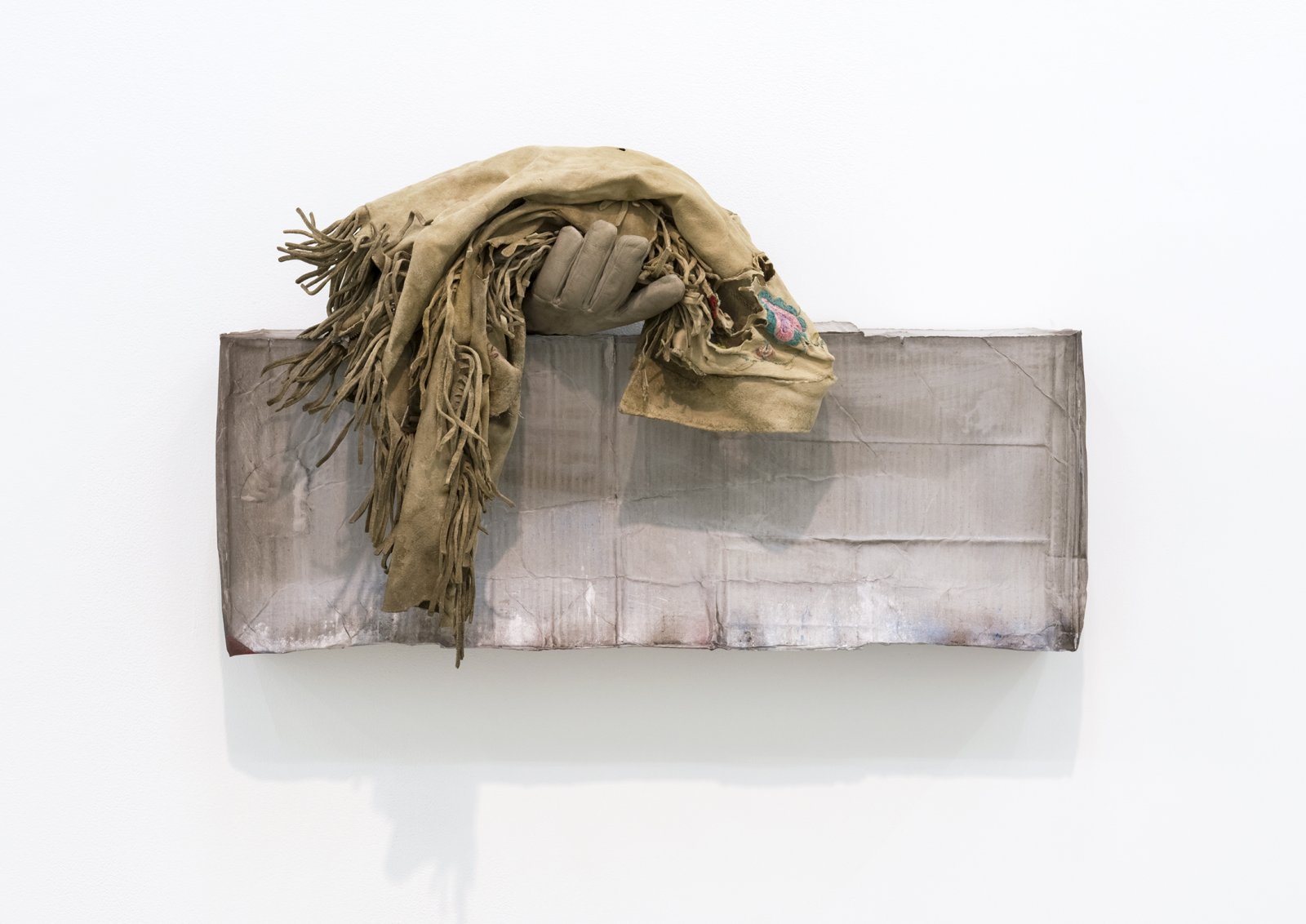 Liz Magor, Still Alive, 2016, polymerized gypsum, deerskin jacket, 19 x 34 x 11 in. (48 x 86 x 27 cm) by Liz Magor