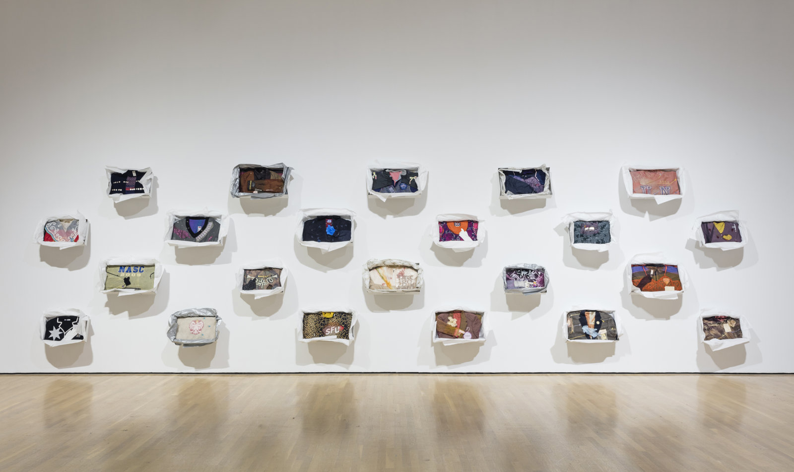 Liz Magor, Being This, 2012, 24 boxes, paper, textiles, found materials, each approximately 12 x 19 x 3 in. (31 x 48 x 6 cm). Installation view, Habitude, Musée d’art contemporain de Montréal, 2016