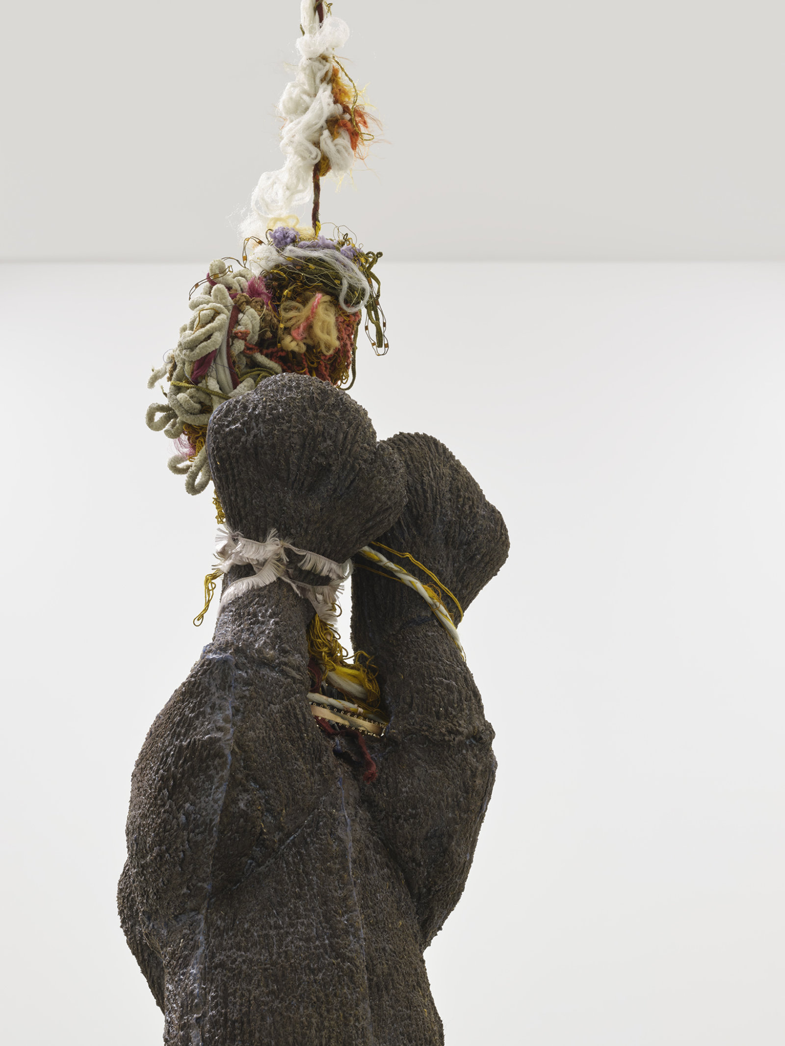 Liz Magor, Delivery (brown), 2018, silicone rubber, textiles, twine, 191 x 42 x 42 in. (485 x 107 x 107 cm)