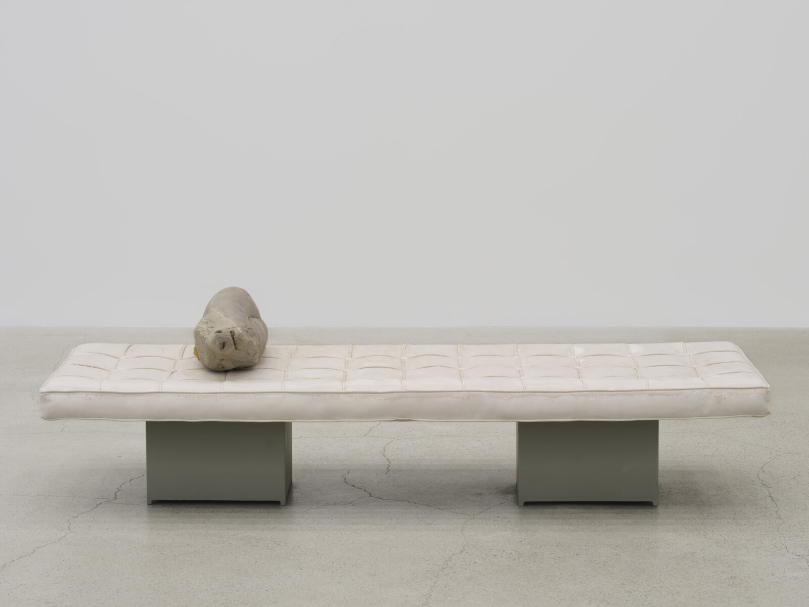 Liz Magor, Extension, 2025, polymerized gypsum, synthetic hair, wood, 20 x 70 x 23 in. (51 x 178 x 58 cm)