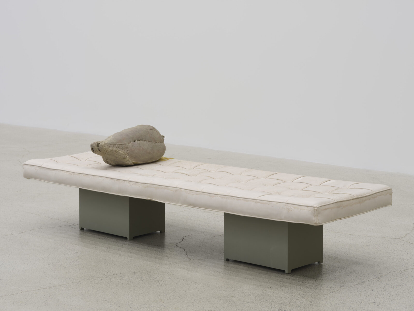 Liz Magor, Extension, 2025, polymerized gypsum, synthetic hair, wood, 20 x 70 x 23 in. (51 x 178 x 58 cm)