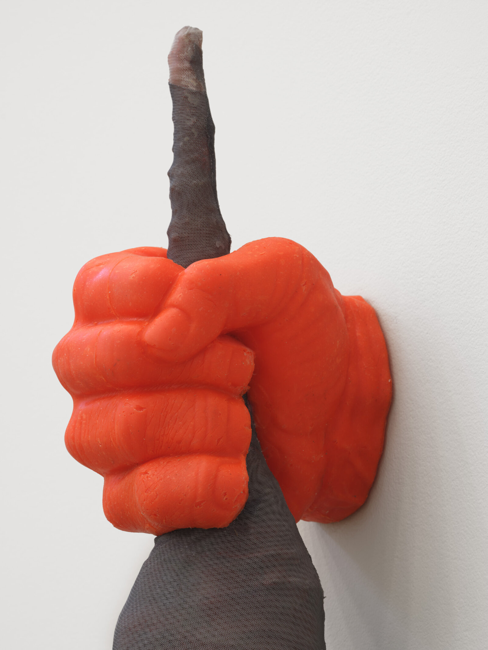 Liz Magor, Fist (orange) (detail), 2025, silicon rubber, polyester mesh, upholstery tacks, 84 x 9 x 6 in. (213 x 22 x 15 cm)