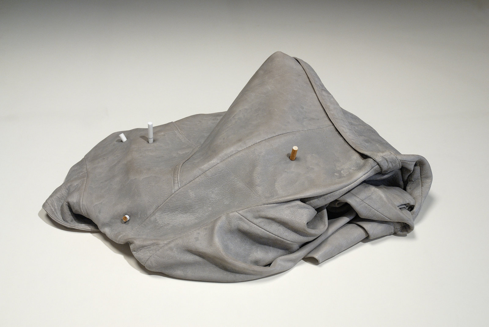 Liz Magor, Leather (4 cig), 2008, polymerized gypsum, cigarettes, 7 x 17 x 24 in. (17 x 43 x 61 cm)