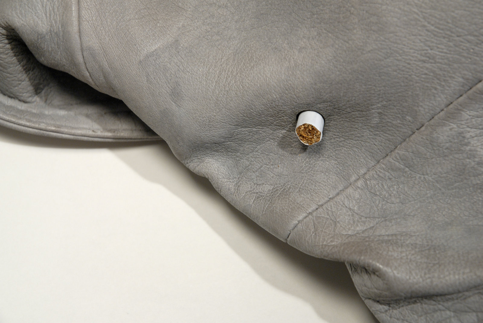 Liz Magor, Leather (4 cig) (detail), 2008, polymerized gypsum, cigarettes, 7 x 17 x 24 in. (17 x 43 x 61 cm)