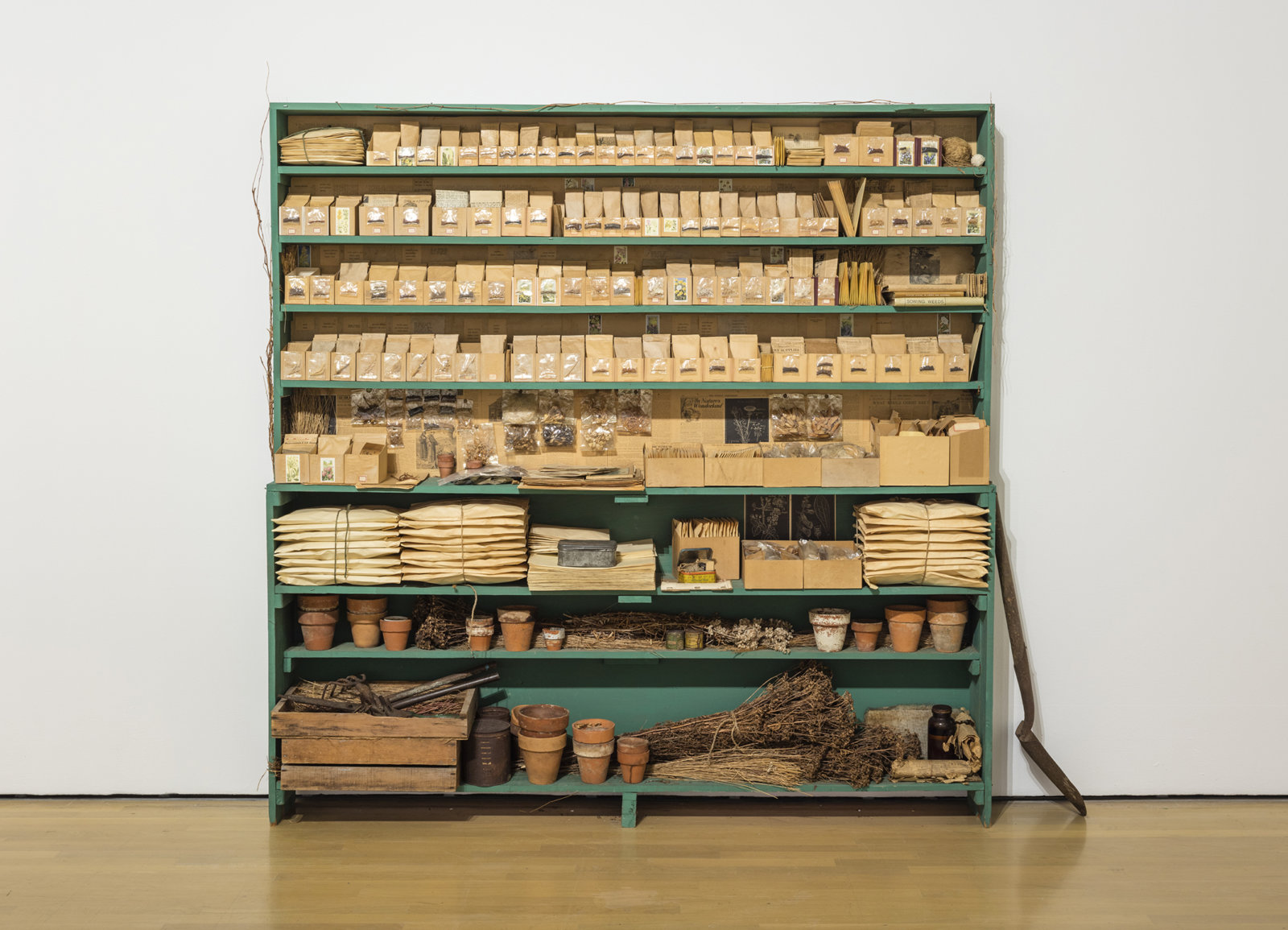 Liz Magor, Sowing Weeds in Lanes and Ditches, 1976,  wooden shelf, seeds, grass, envelopes, boxes, garden gloves, clay pots, 77 x 77 x 11 in. (196 x 196 x 27 cm)