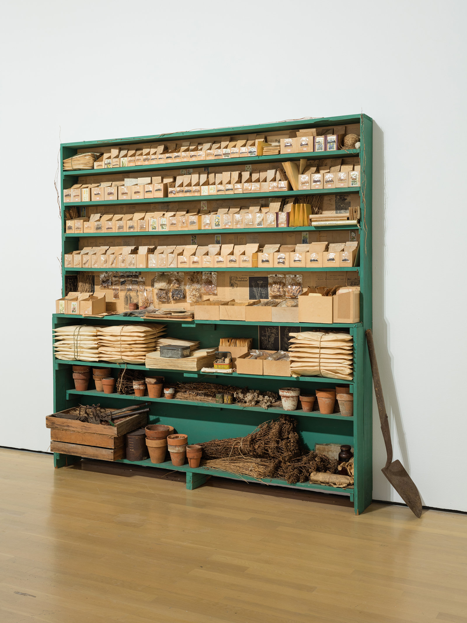 Liz Magor, Sowing Weeds in Lanes and Ditches, 1976,  wooden shelf, seeds, grass, envelopes, boxes, garden gloves, clay pots, 77 x 77 x 11 in. (196 x 196 x 27 cm)
