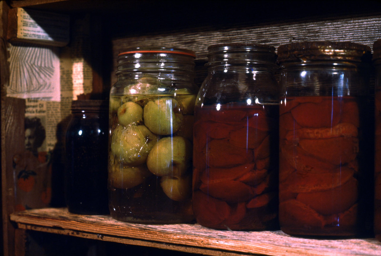 Liz Magor, Time and Mrs. Tiber (detail), 1976, wooden shelf with jars of preserves, recipe box, forks, glass tops, rubber sealers, metal lids, cardboard boxes, enamel cup, tin can, 84 x 36 x 13 in. (214 x 91 x 32 cm)