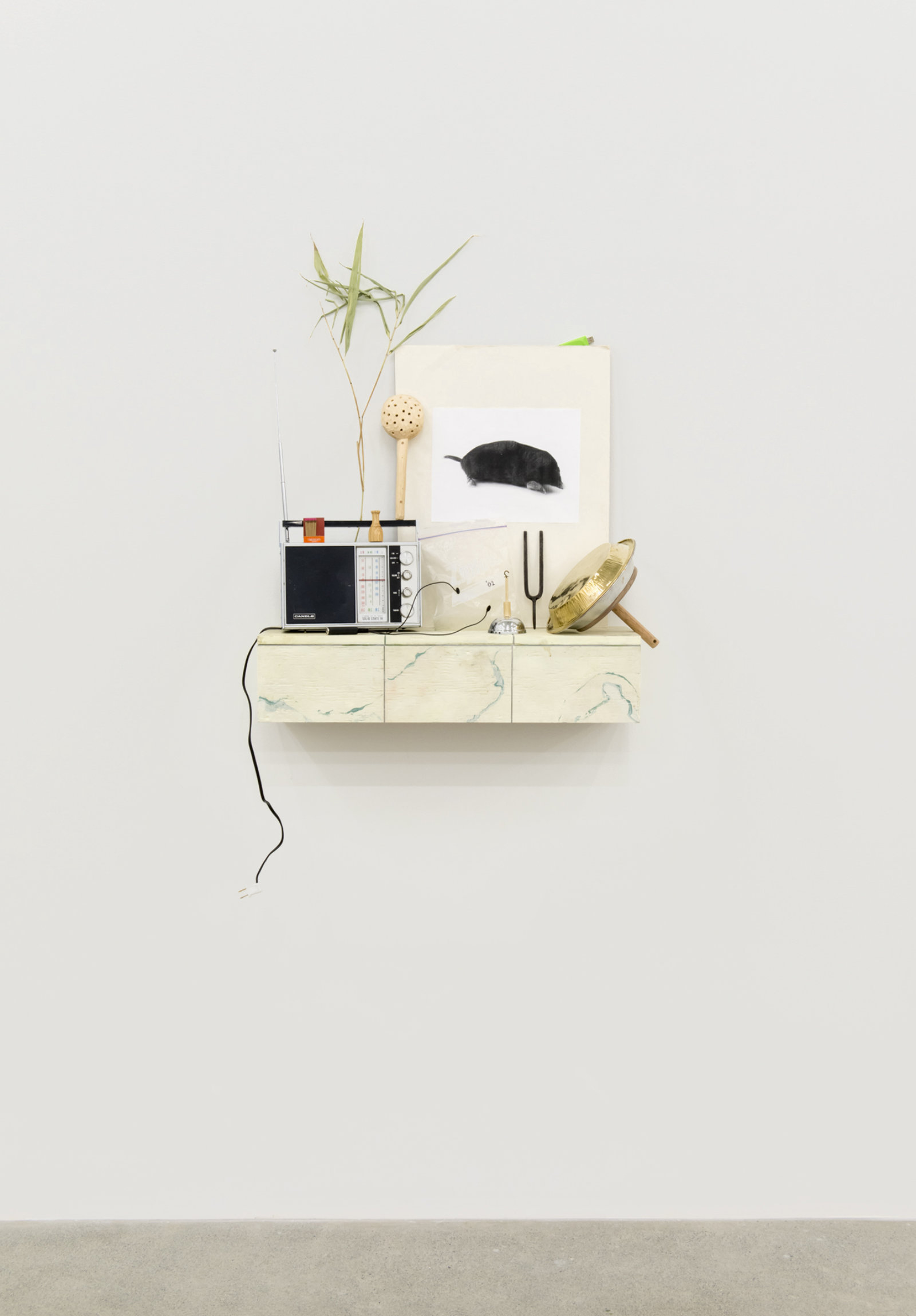 Ashes Withyman, Cetus, Compass, River, Furnas, Musca, Altar, Cup, 2017–2018, radio, matches, animal call, wood and stone rattle, photocopy, grass, usb flash drive, gold plated tin, sand, ziploc bag with contact microphone, tuning fork, dried grass, bell, painted plywood, 52 x 29 x 9 in. (132 x 74 x 23 cm)