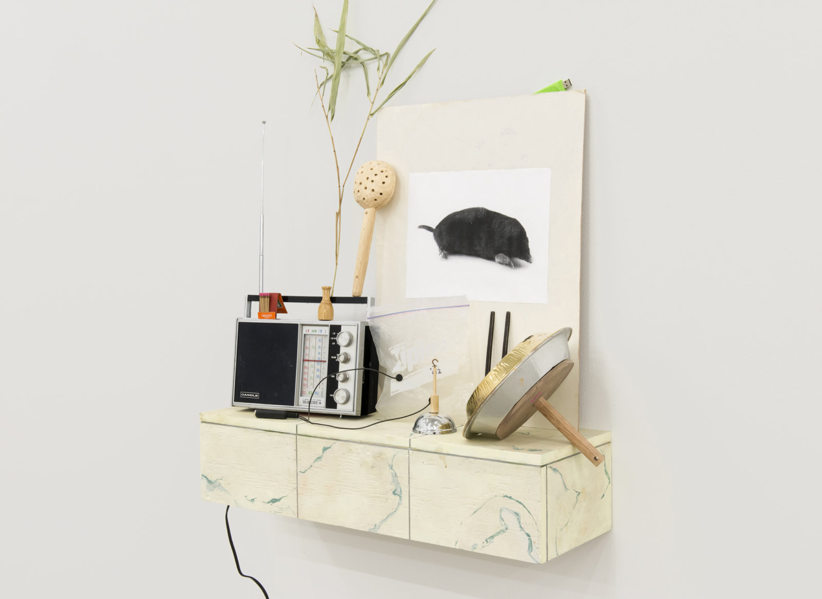 Ashes Withyman, Cetus, Compass, River, Furnas, Musca, Altar, Cup, 2017–2018, radio, matches, animal call, wood and stone rattle, photocopy, grass, usb flash drive, gold plated tin, sand, ziploc bag with contact microphone, tuning fork, dried grass, bell, painted plywood, 52 x 29 x 9 in. (132 x 74 x 23 cm)