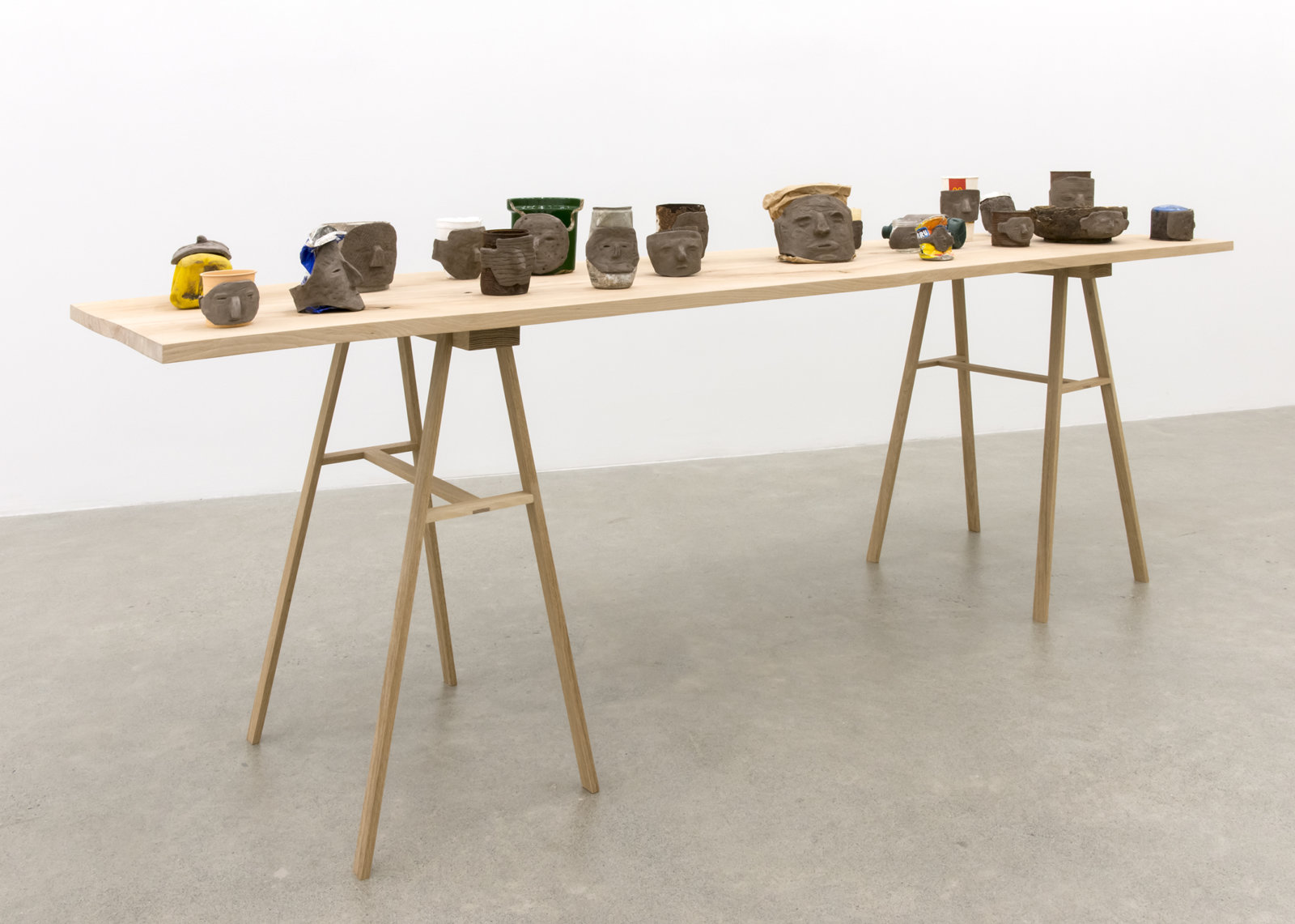 Ashes Withyman, Funeral Vessels, 2014–2017, found objects and unfired clay dredged from the Forth and Clyde canal, Glasgow, 40 x 96 x 23 in. (100 x 243 x 58 cm)