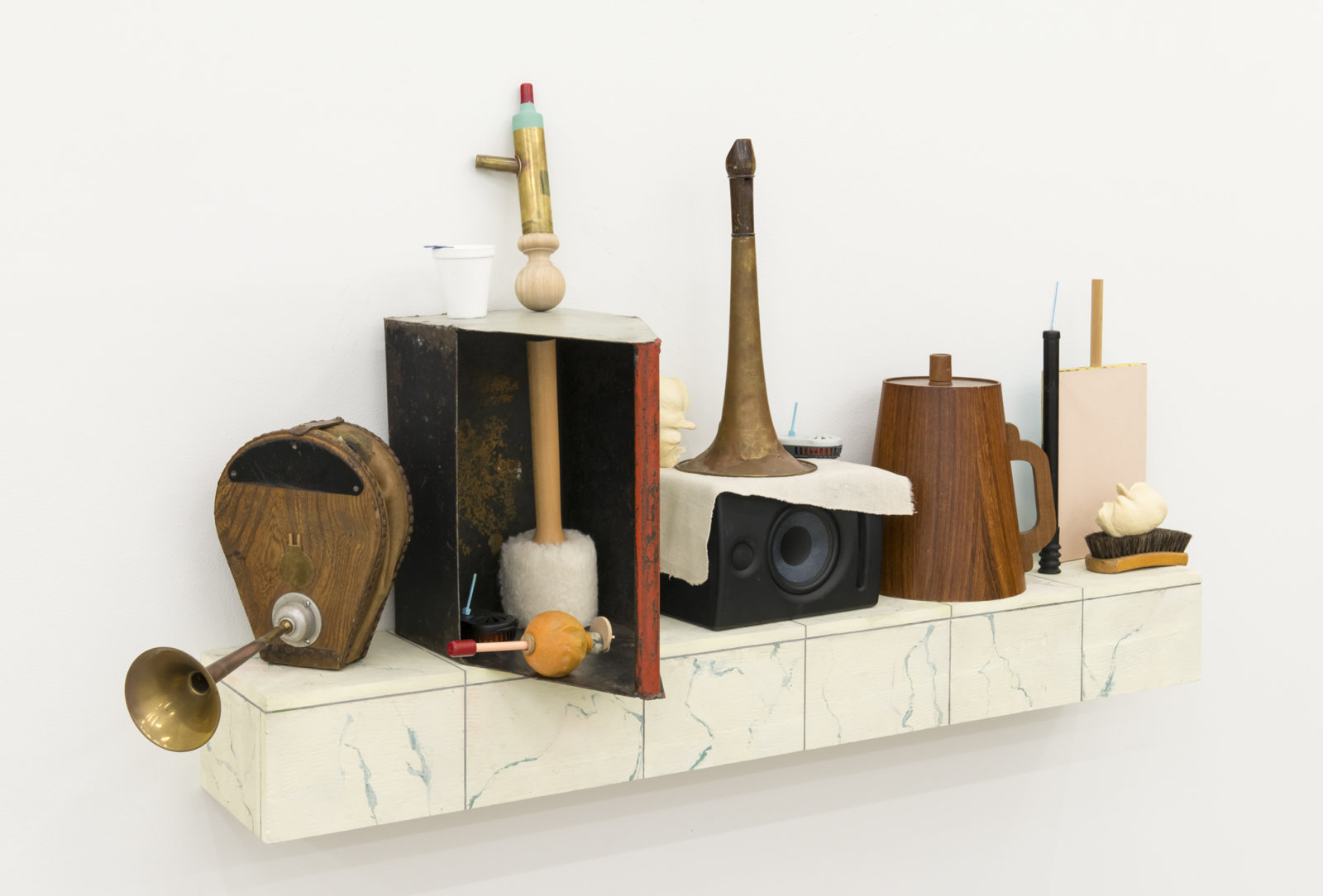 Ashes Withyman, Furnas, Compass, Altar, Musca, River, Cetus, Cup, 2017–2018, tool box, styrofoam cup, mallet, brass horn, bullae, mosquito repelling devices, shoe brush, paper, wood, brass, animal call parts, musical instrument parts, pump, speaker, painted plywood, 34 x 63 x 14 in. (86 x 160 x 34 cm)