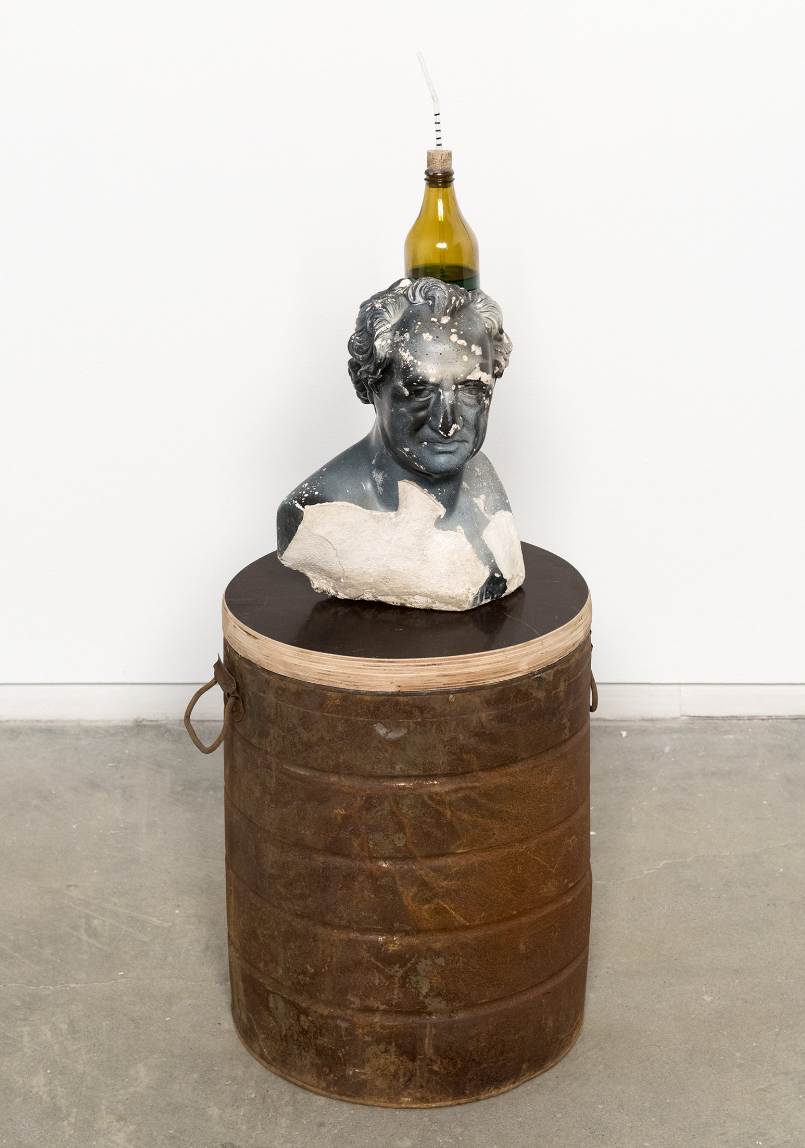 Ashes Withyman, Goethe Barometer from a place, near the buried canal, 2011–2012, bust found in trash, glass bottle, cork, drinking straw, coloured water, enamel paint, wood, metal, beeswax, 36 x 12 x 12 in. (91 x 30 x 30 cm)