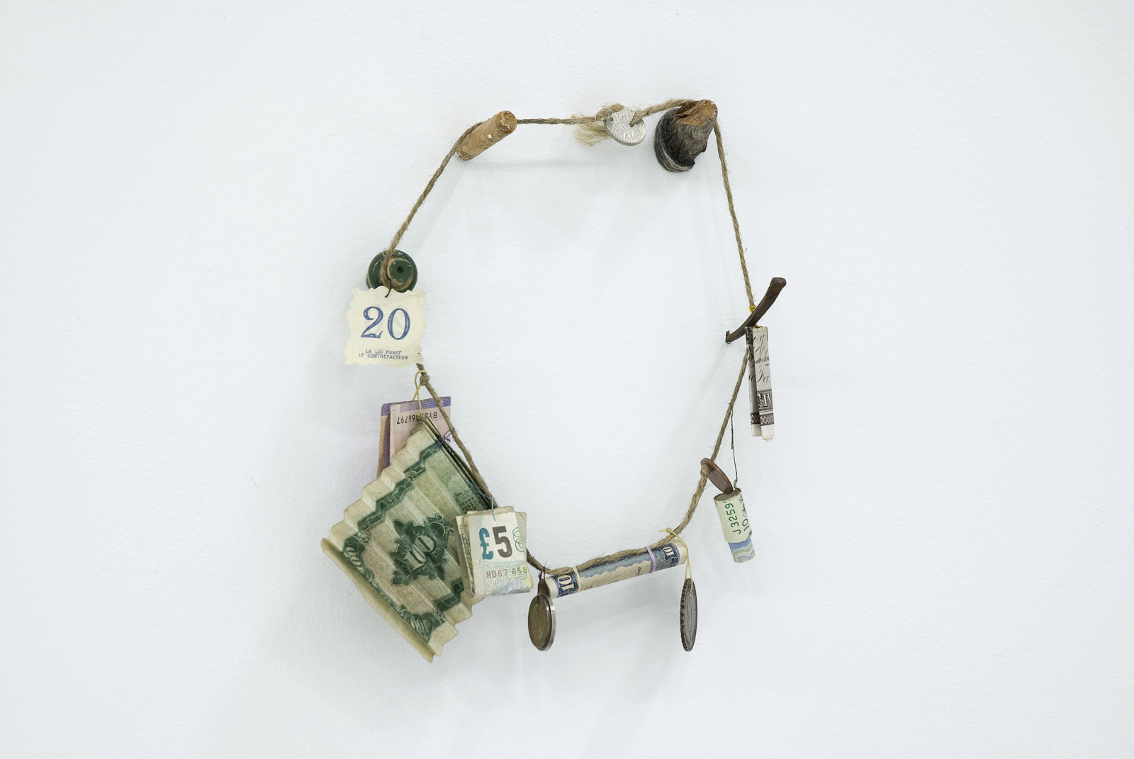 Ashes Withyman, Necklace from Uncertain Pilgrimage, 2006-2009, string, thread, found wood, nail, various past and present currencies, 9 x 8 x 2 in. (24 x 20 x 6 cm)