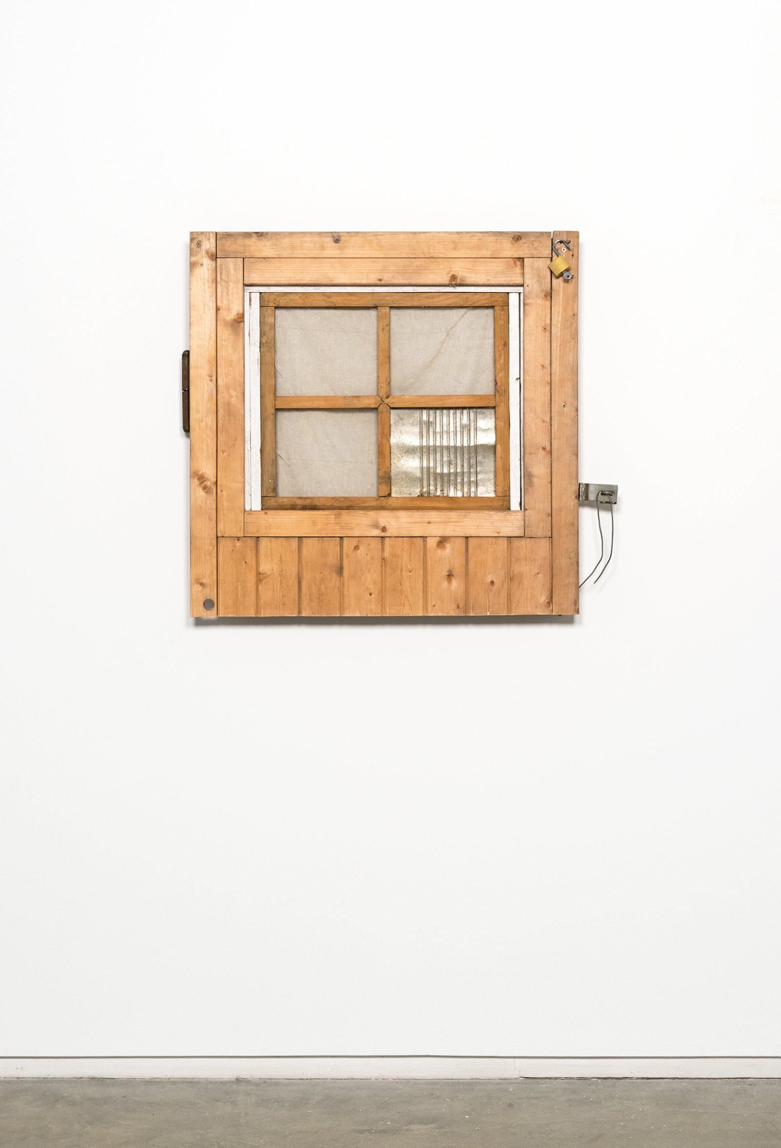 Ashes Withyman, Section of the Groundskeeper’s old door (for B.K.) from a place, near the buried canal, 2011–2012, wood, linen, tin can, lock with key, hinge, 32 x 32 x 3 in. (81 x 82 x 8 cm)