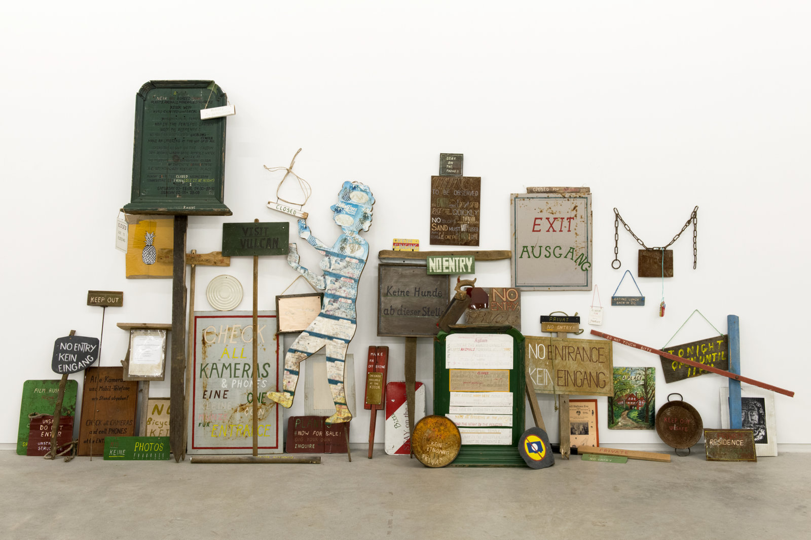 Ashes Withyman, Signs from a place, near the buried canal, 2011–2012, 50 sign works, wood, steel, rope, stone, paper, acrylic and enamel paint, felt marker, 93 x 166 x 17 in. (236 x 422 x 42 cm)