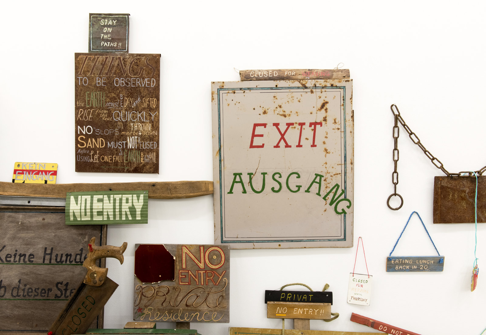 Ashes Withyman, Signs from a place, near the buried canal (detail), 2011–2012, 50 sign works, wood, steel, rope, stone, paper, acrylic and enamel paint, felt marker, 93 x 166 x 17 in. (236 x 422 x 42 cm)