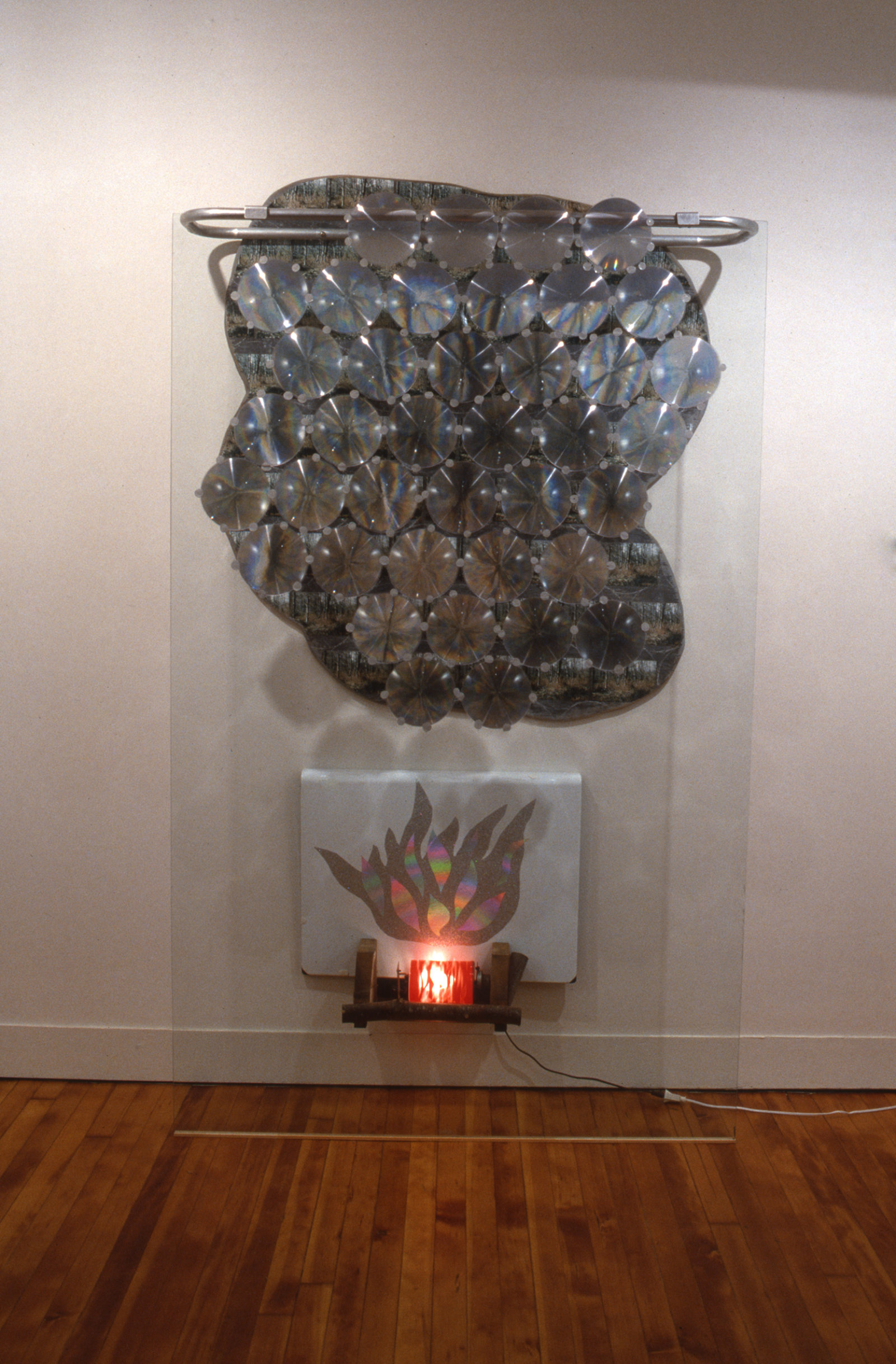 Jerry Pethick, Ancestral Dream, 1993, photographs, stove cement, plywood, aluminum, glass, fresnel lenses, enamelled steel, spectrafoil, light bulb, plastic cylinder, electric motor, wood, 84 x 49 x 12 in. (213 x 125 x 31 cm)