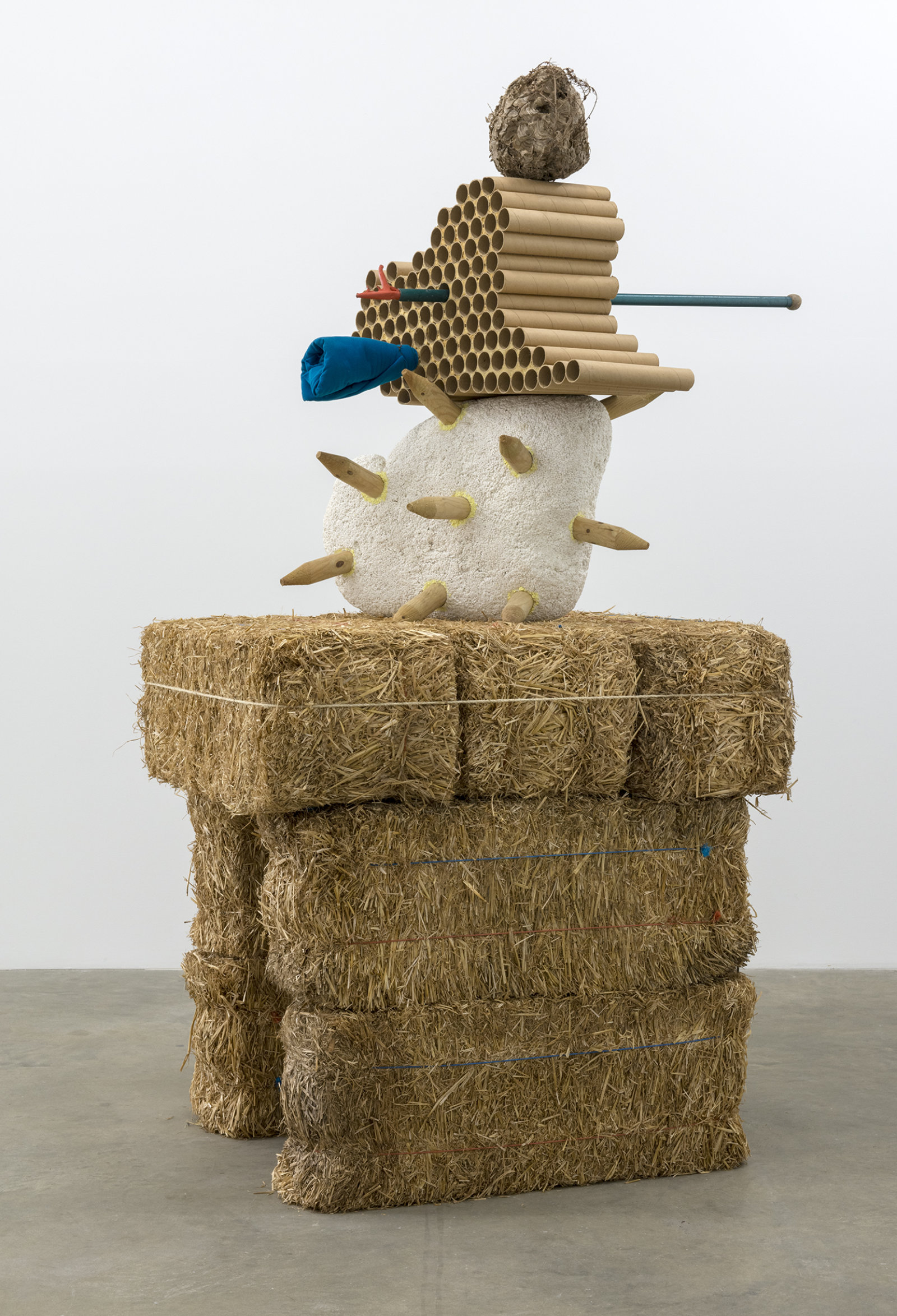 Jerry Pethick, Gobi Clone, 1996/1997, straw bales, styrofoam, wood, cardboard, hornet's nest, anodized aluminum, polypropylene rope, cloth, orange rubber, iron wire, sulphur, dried fir needles, 107 x 55 x 46 in. (272 x 140 x 117 cm)