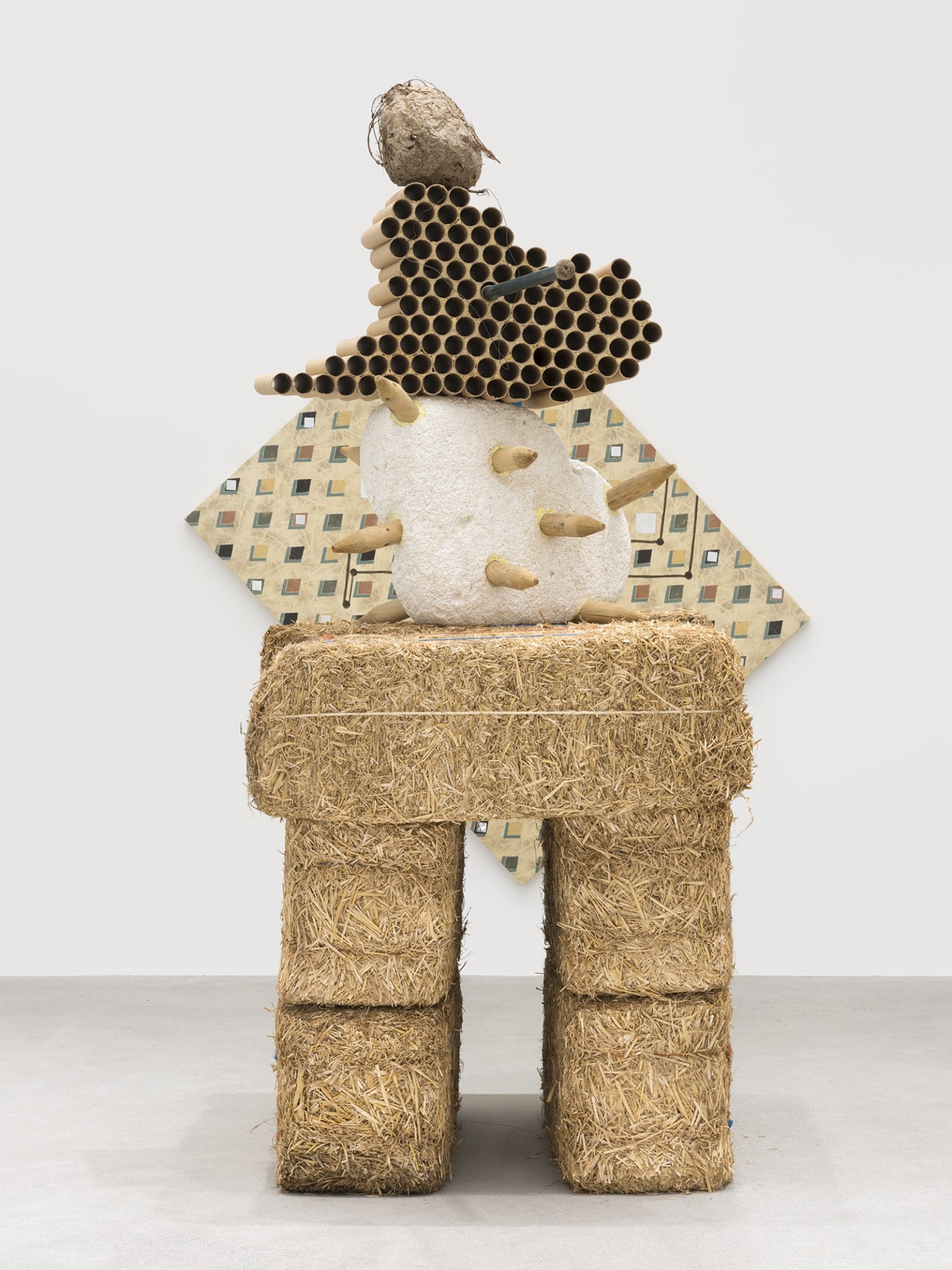 Jerry Pethick, Gobi Clone, 1996/1997, straw bales, styrofoam, wood, cardboard, hornet’s nest, anodized aluminum, polypropylene rope, cloth, orange rubber, iron wire, sulphur, dried fir needles, 107 x 55 x 46 in. (272 x 140 x 117 cm). Installation view, Unexplained Parade, Catriona Jeffries, Vancouver, February 9, 2019