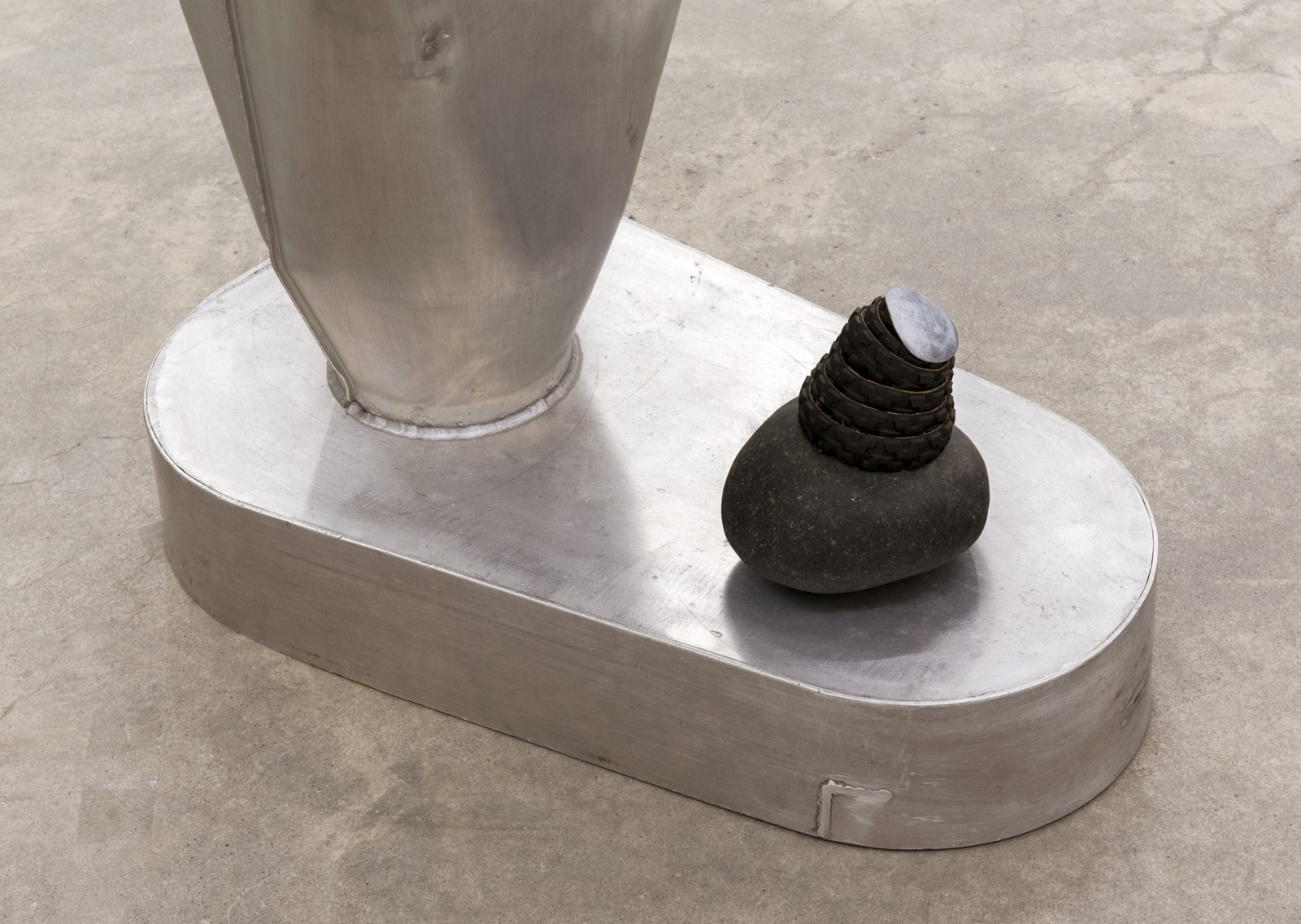 Jerry Pethick, Kolossus of Kindergarden (detail), 1987–1989, spectra-foil on records, aluminium, blown glass, wood, rock, tires, cargo blanket, dimensions variable