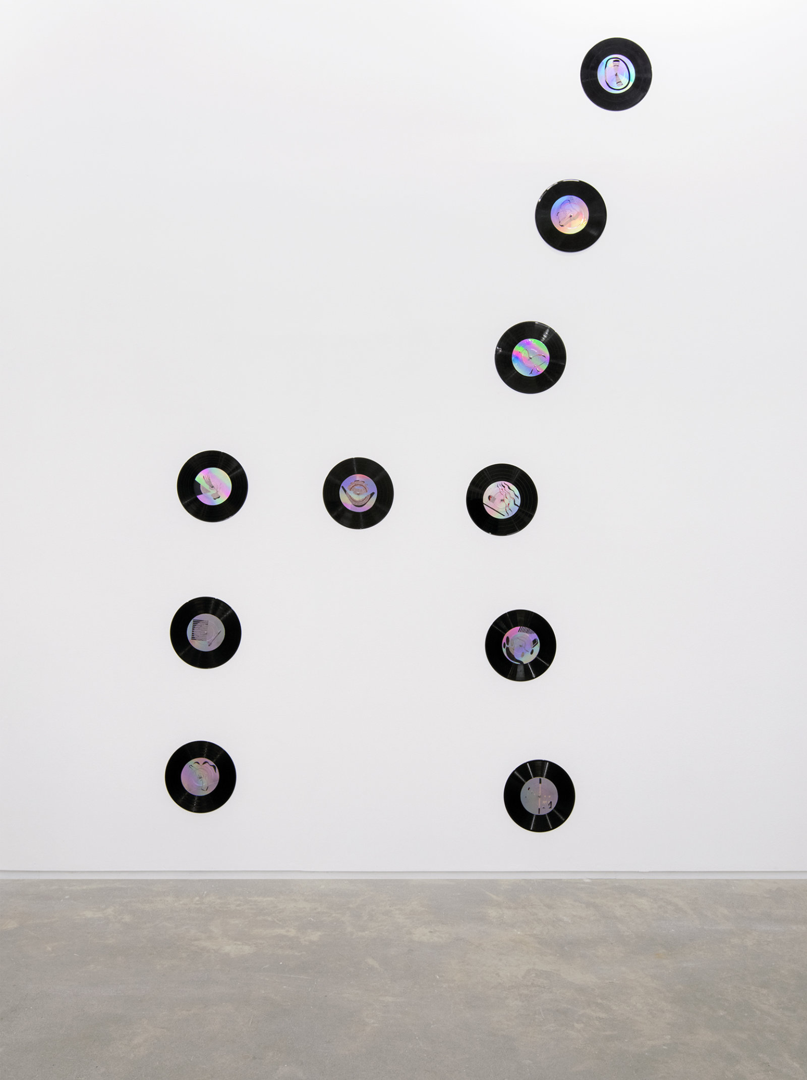 Jerry Pethick, Kolossus of Kindergarden (detail), 1987–1989, spectra-foil on records, aluminium, blown glass, wood, rock, tires, cargo blanket, dimensions variable