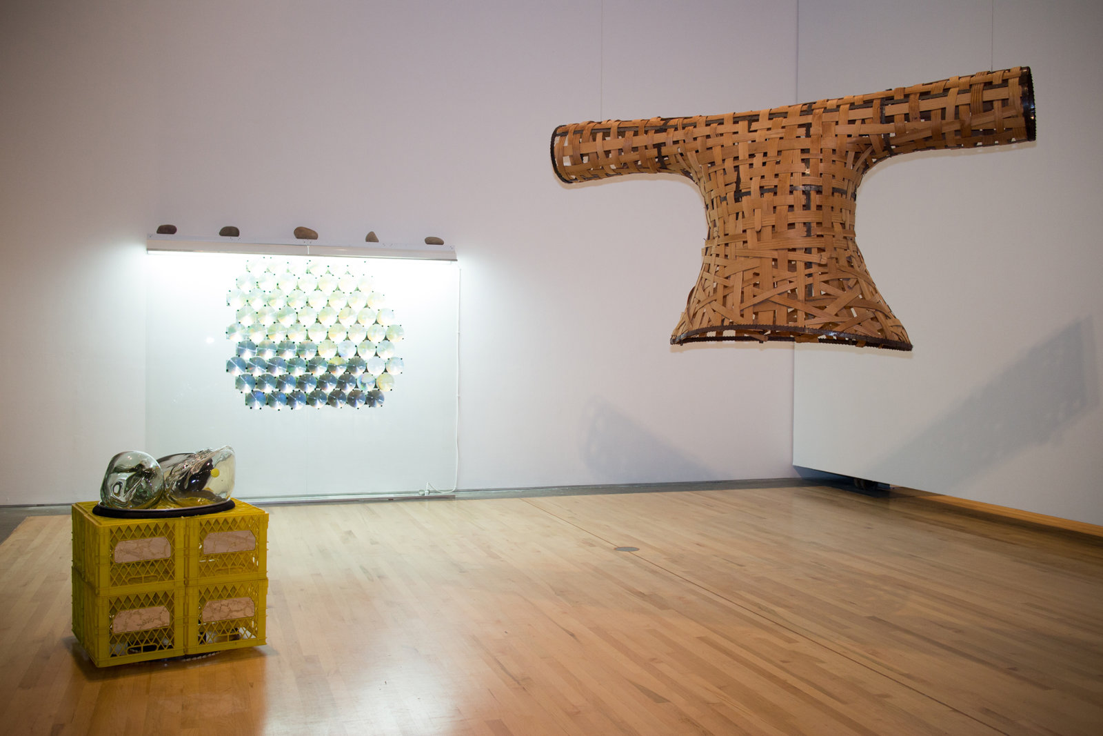 Jerry Pethick, Semaphore Goya, 1991, woven wicker shirt, cable, milk crates, blown glass shapes, coal, aluminum ring, saw blades, glass, light fixtures, river rocks, photographs, fresnel lenses, mirrors, small yellow glass, 157 x 197 x 177 in. (399 x 500 x 450 cm)