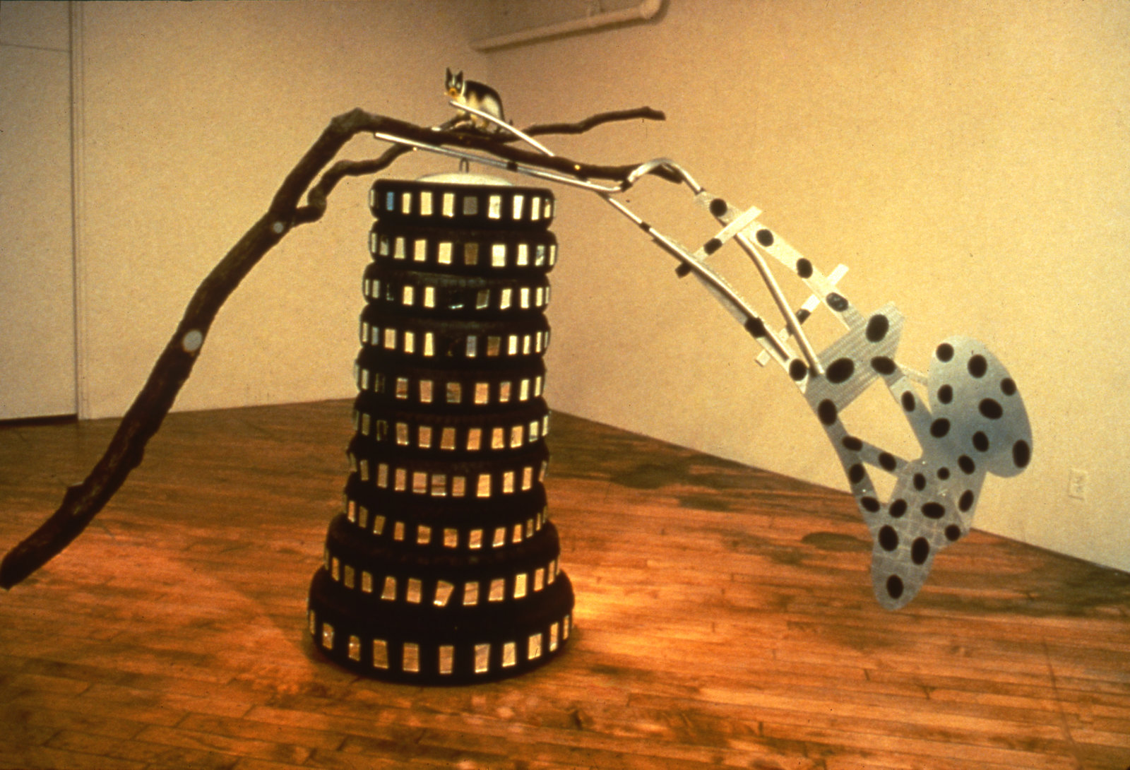 Jerry Pethick, Toy Tower/Whose Limbs are we out on?, 1985, rubber tires, aluminum, mirror, silicone, glass, wooden branch, 118 x 75 x 33 in. (300 x 190 x 84 cm)