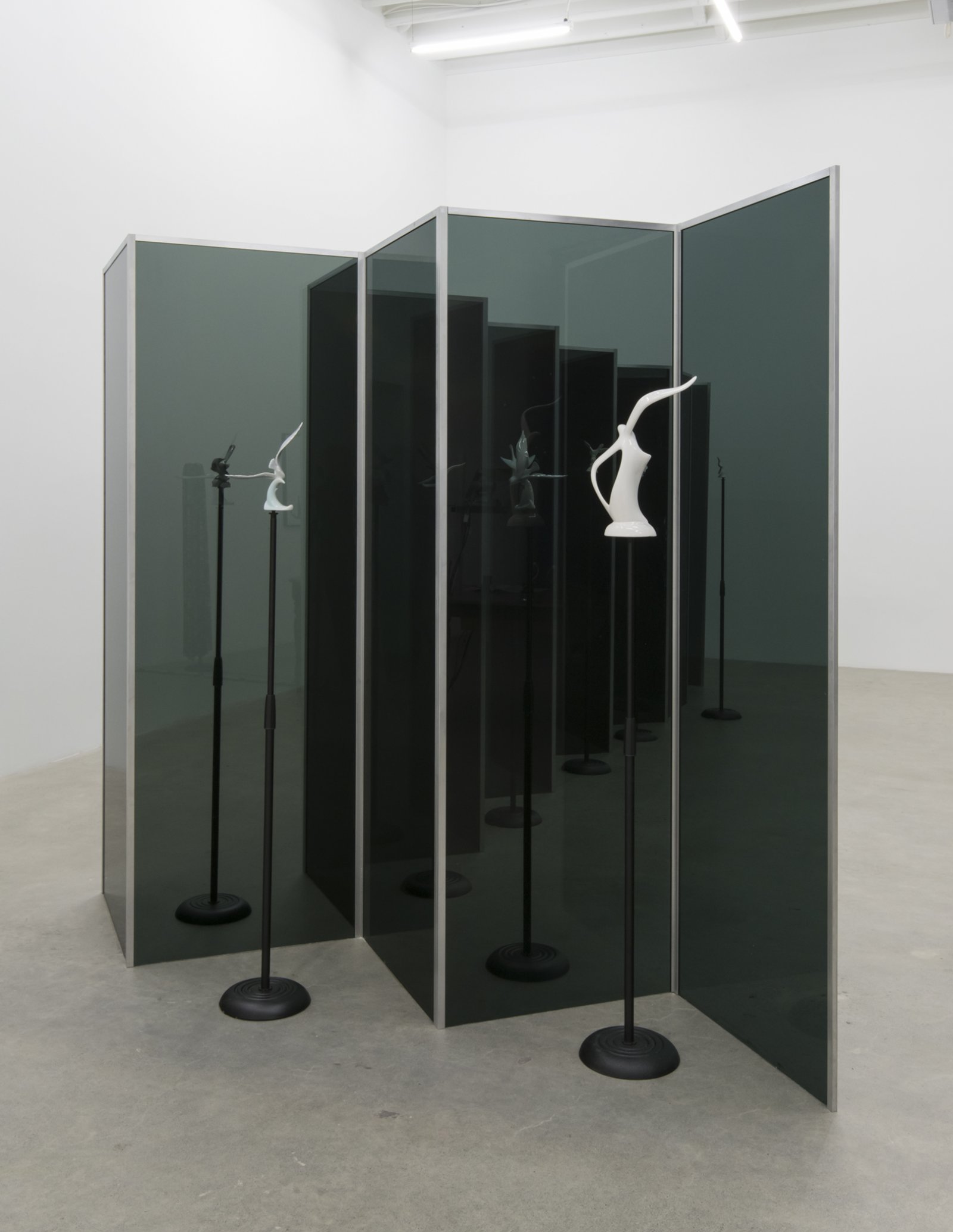 ​​Judy Radul, Connector Divider (Hawks, Sparrows, Pigeons, Doves, Ducks, Eagles), 2018, salvaged glass, aluminum, found ceramic figurines, microphone stands, dimensions variable​​​ by Judy Radul