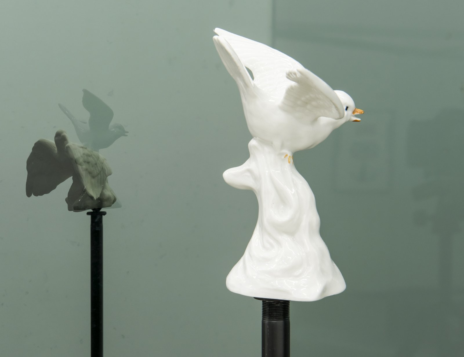 ​​Judy Radul, Connector Divider (Hawks, Sparrows, Pigeons, Doves, Ducks, Eagles) (detail), 2018, salvaged glass, aluminum, found ceramic figurines, microphone stands, dimensions variable​ by Judy Radul