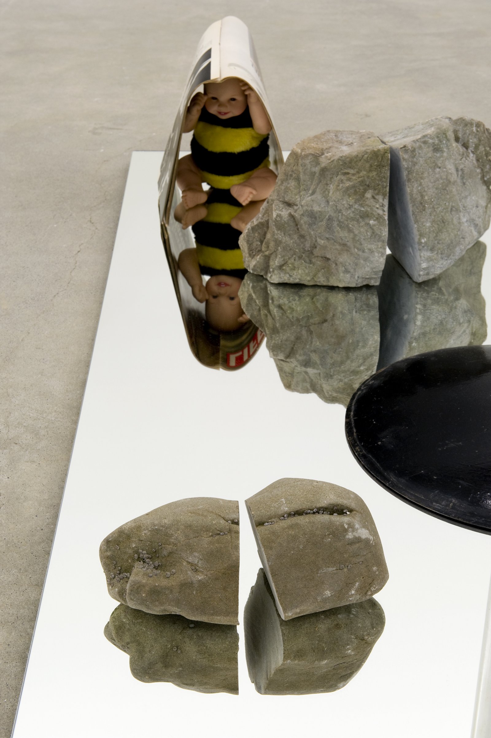 ​Judy Radul, The Brain Display ​(detail), 2010, mirror, wood, 5 stones, plastic book holder, Life magazines, doll, 67 x 40 x 80 in. (170 x 102 x 203 cm)​ by Judy Radul
