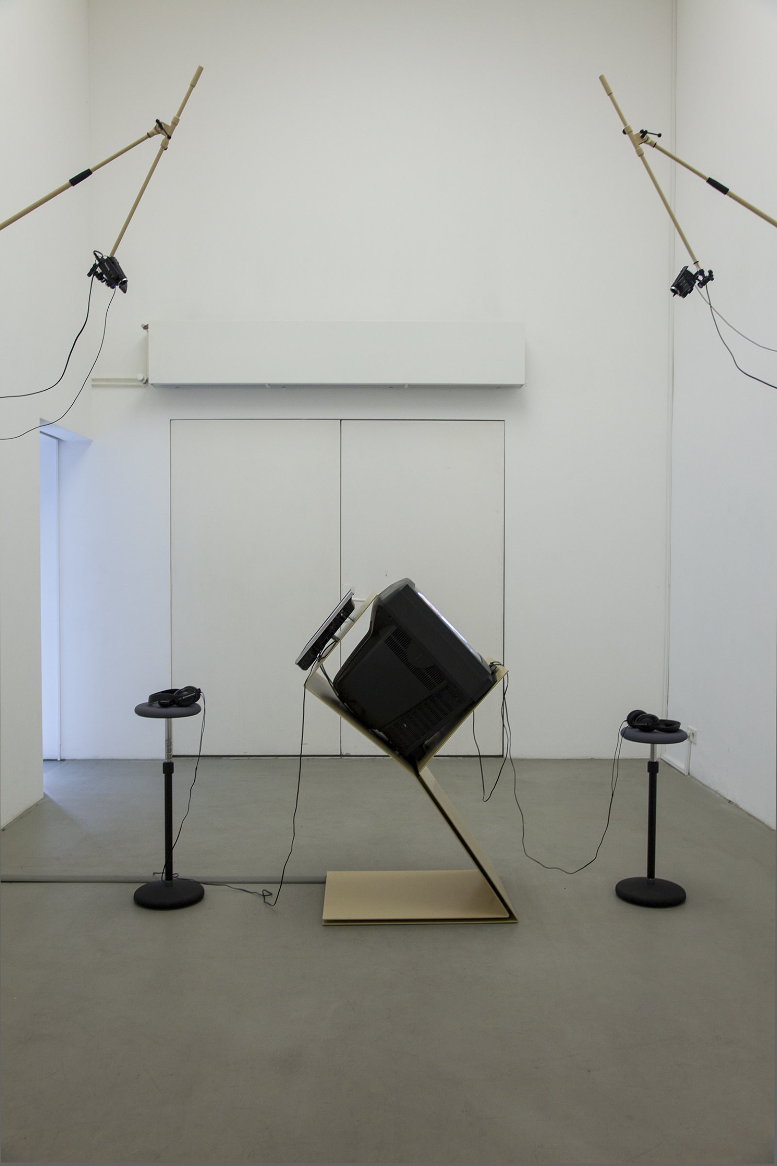Judy Radul, A CONTAINER CONTAINING NOT ONE TV, 2013, powder coated steel, CRT television, 2 flatscreen televisions, local television signal, remote control, two live video cameras, maxmsp patch, dimensions variable. Installation view, This	is	Television,	Daadgalerie,	Berlin,	Germany, 2013
