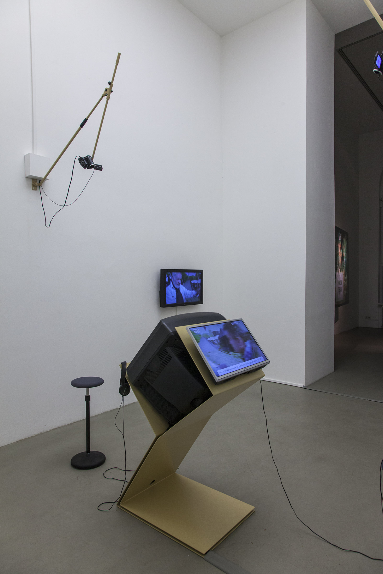 Judy Radul, A CONTAINER CONTAINING NOT ONE TV, 2013, powder coated steel, CRT television, 2 flatscreen televisions, local television signal, remote control, two live video cameras, maxmsp patch, dimensions variable. Installation view, This	is	Television,	Daadgalerie,	Berlin,	Germany, 2013
