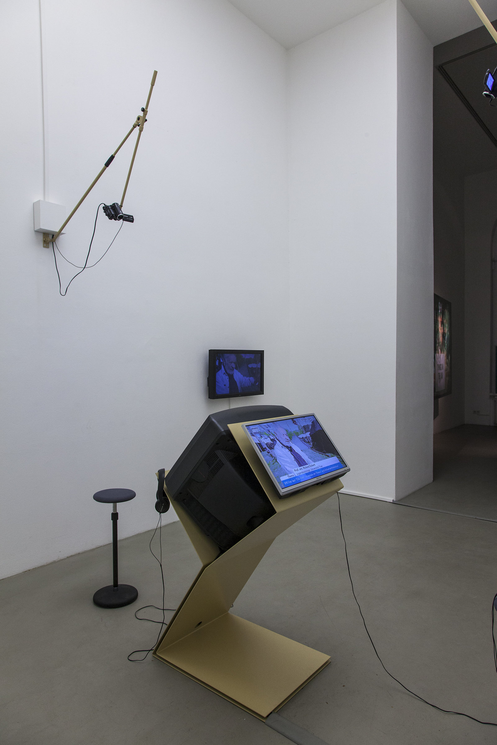 Judy Radul, A CONTAINER CONTAINING NOT ONE TV, 2013, powder coated steel, CRT television, 2 flatscreen televisions, local television signal, remote control, two live video cameras, maxmsp patch, dimensions variable. Installation view, This	is	Television,	Daadgalerie,	Berlin,	Germany, 2013