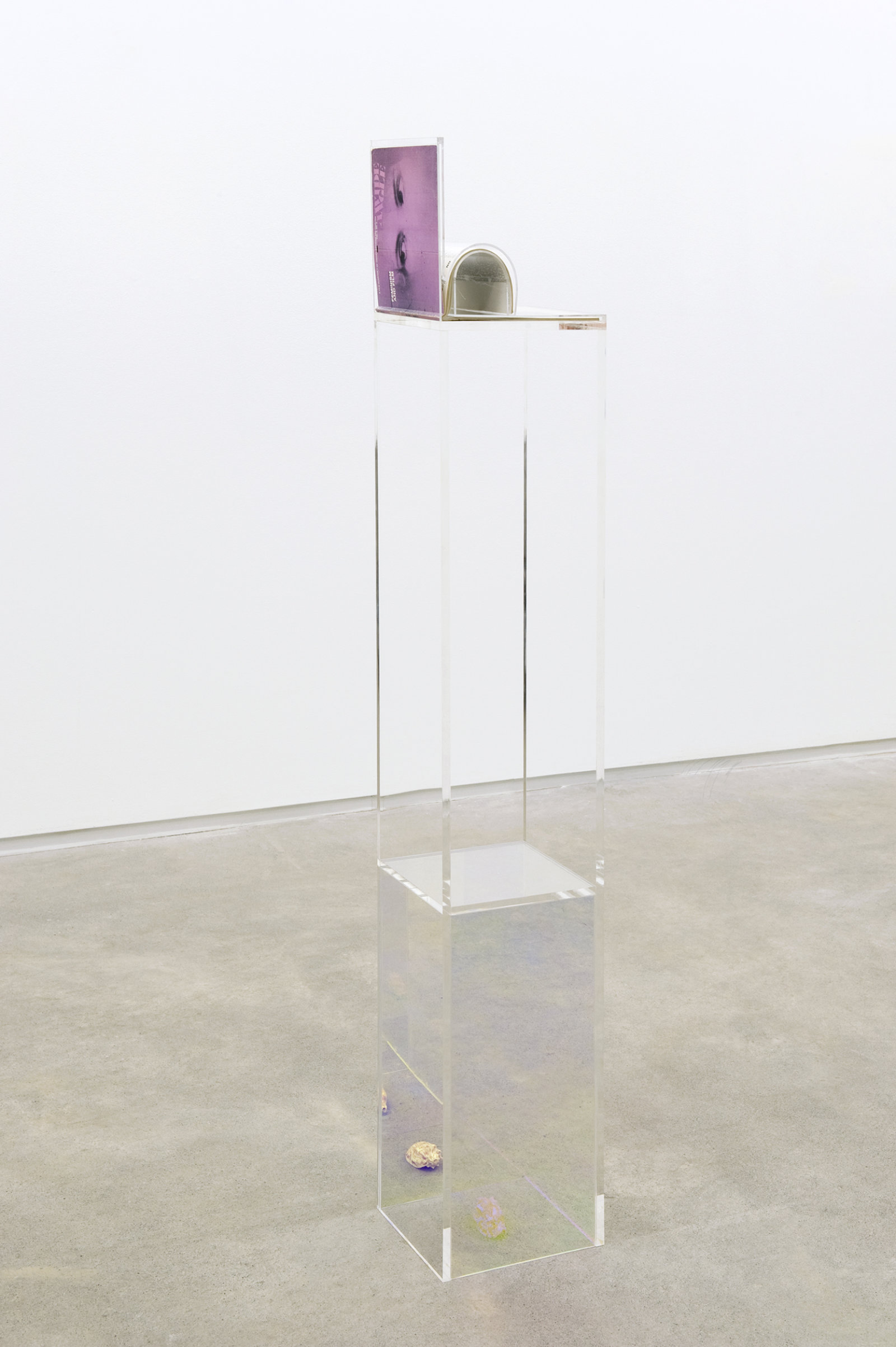 Judy Radul, Women and Film, 2011, dichroic and clear acrylic, copy of Wide Angle magazine (vol. 6, no. 3, special issue on Feminism and Film, 1984), seashell, 60 x 8 x 9 in. (152 x 20 x 23 cm)