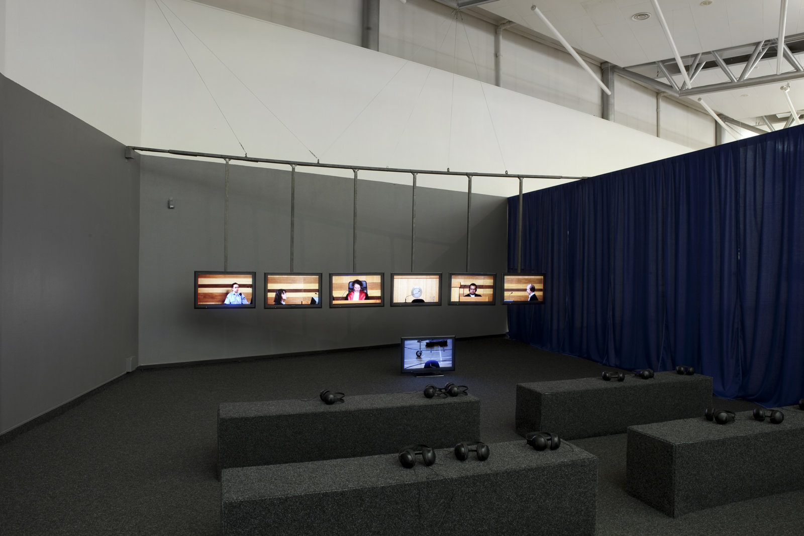 Judy Radul, World Rehearsal Court, 2009, 7 channel video installation, running time 4 hours; 4 servo-controlled cameras, live camera position playback system, monitors, dolly, track, found and built objects, plexiglass, dimensions variable. Installation view, World Rehearsal Court, Henie Onstad Kunstsenter, Høvikodden, Norway, 2011