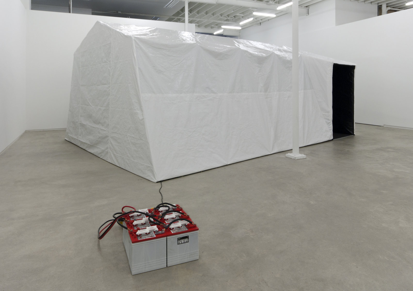 Kevin Schmidt, Autonomous Projection Room #1, 2010, tarp, portable garage frame, carpet, roxul, projector, home stereo system, screen, batteries, inverter, camping chairs, 181 x 60 x 105 in. (460 x 152 x 267 cm)