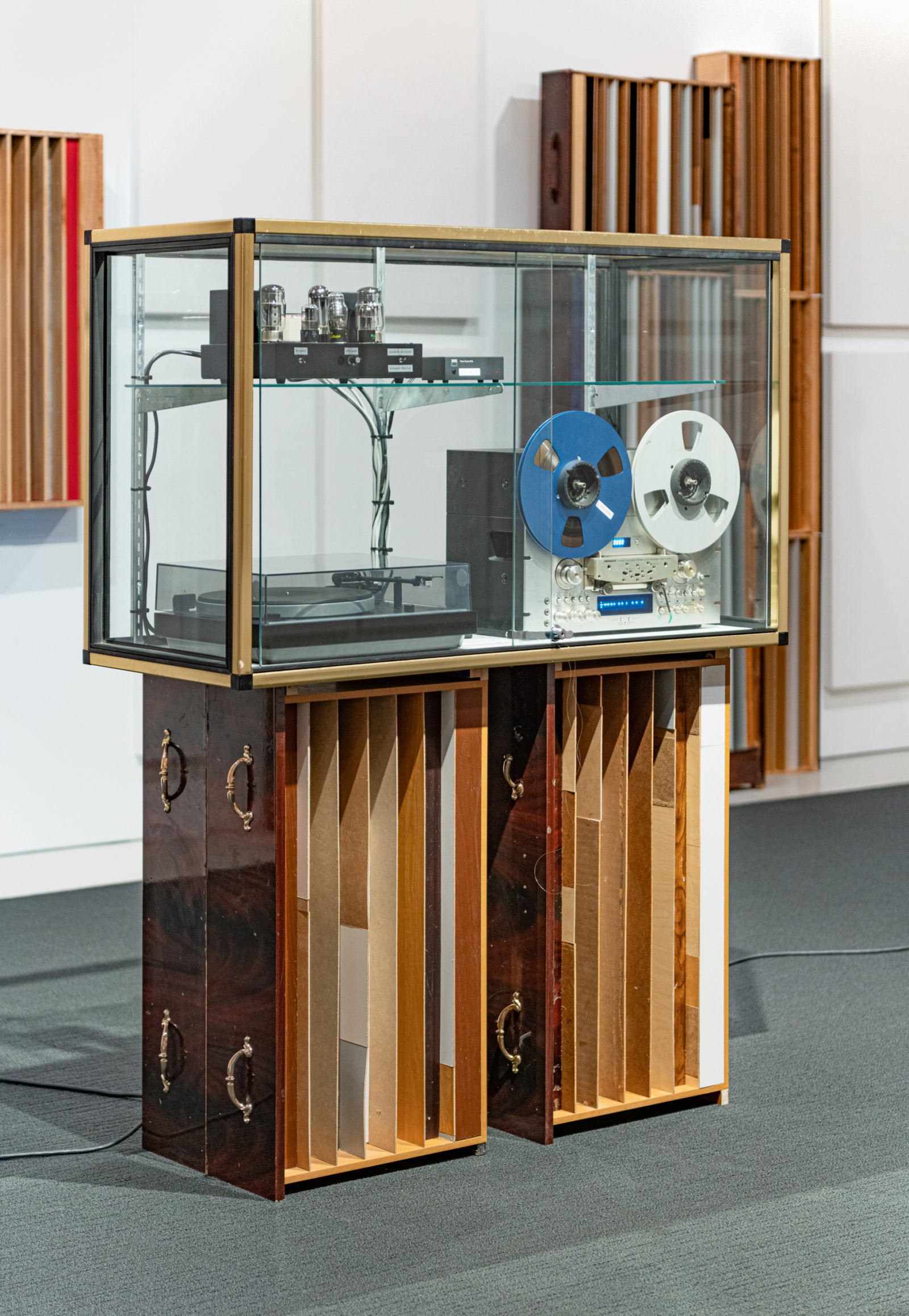 Kevin Schmidt, Enclosures, 2022, glass cabinet, discarded furniture, console, reel-to-reel player, field recording, 48 x 36 x 18 in. (122 x 91 x 46 cm). Installation view, Public Address System, Musée d’art de Joliette, Canada, 2022