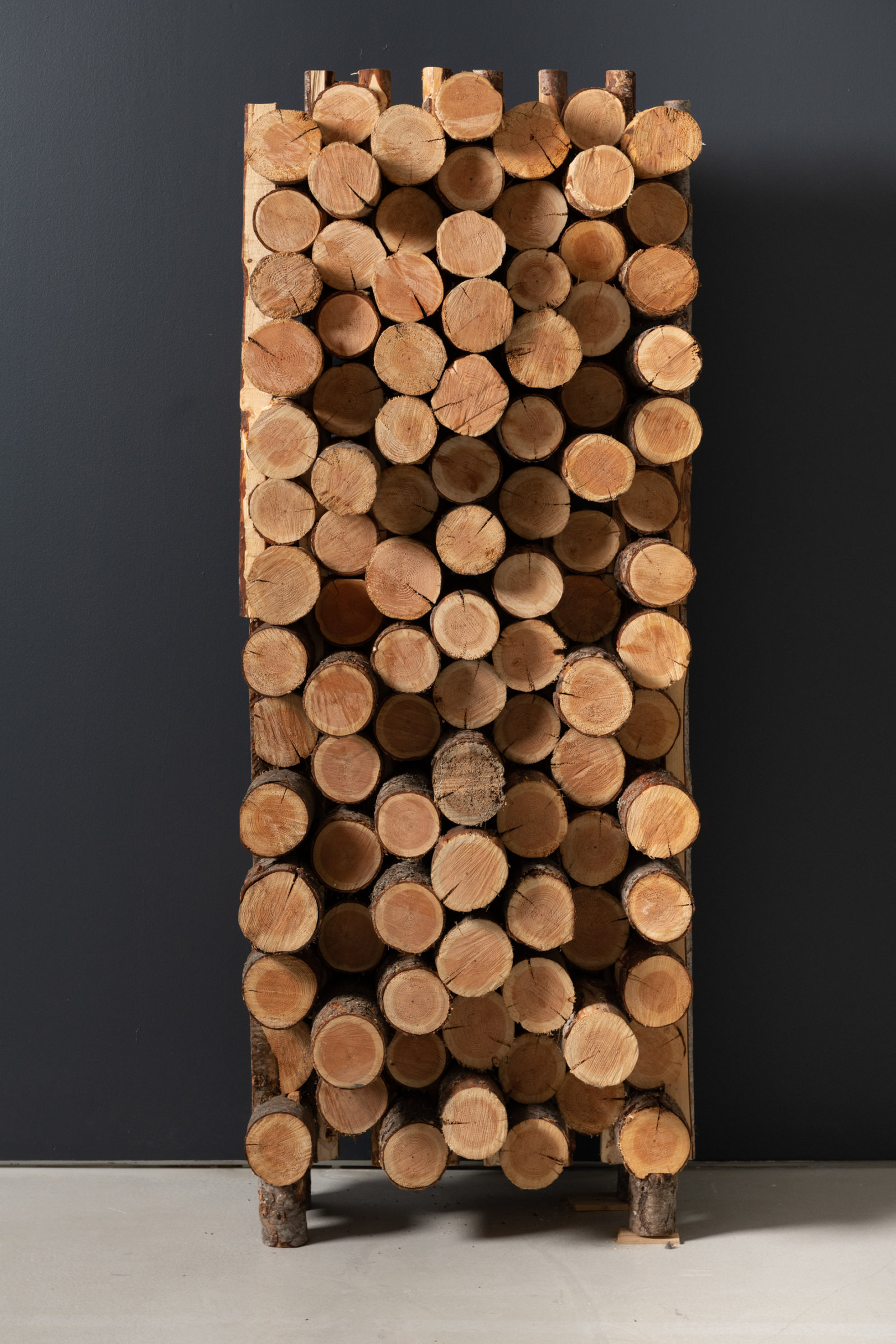 Kevin Schmidt, Excess Dispersion #3, 2022, residual logs from industrial forestry operations, 78 x 36 x 21 in (198 x 91 x 53 cm)