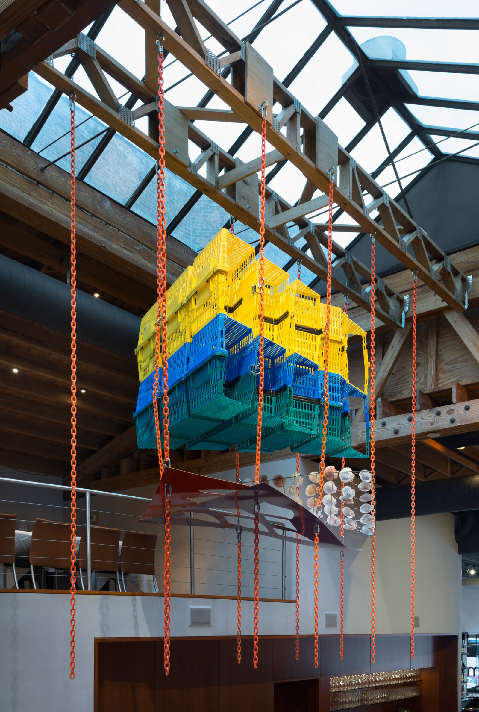 Jessica Stockholder, Another Piece of Pie, 2015, plastic shopping baskets, metal plate, paint, chains, hardware, metal rod, scallop shells, 144 x 132 x 72 in. (366 x 335 x 183 cm). Installation view, MN Restaurant, Chicago, USA